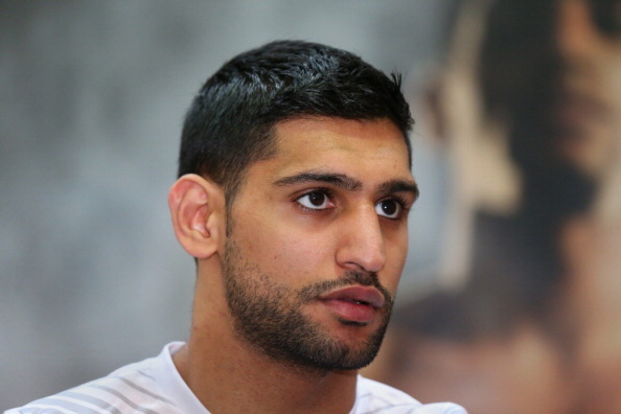 BOLTON, ENGLAND - MARCH 24: Amir Khan looks on as he tapes his hands up prior to a media workout at the Gloves Community Centre on March 24, 2014 in Bolton, England. (Photo by Alex Livesey/Getty Images) BOLTON, ENGLAND - MARCH 24: Amir Khan looks on as he tapes his hands up prior to a media workout at the Gloves Community Centre on March 24, 2014 in Bolton, England. (Photo by Alex Livesey/Getty Images)