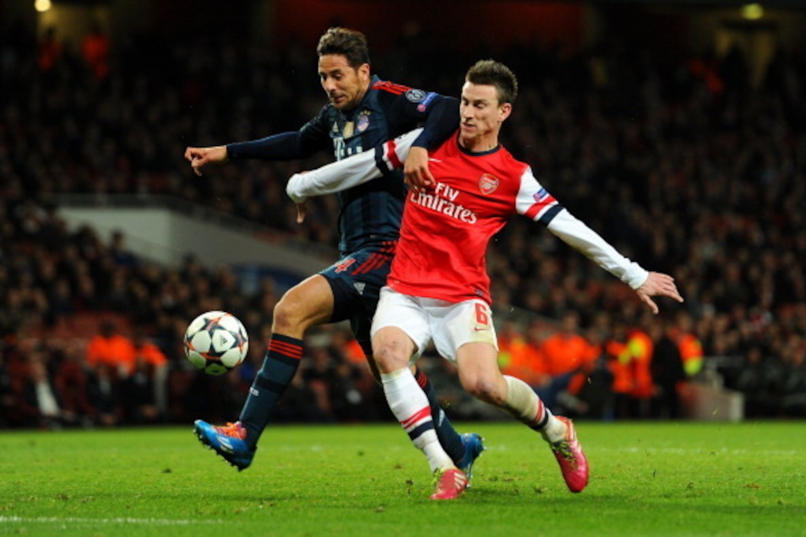 LONDON, ENGLAND - FEBRUARY 19:  Laurent Koscielny of Arsenal tackles Claudio Pizarro of Bayern Muenchen during the UEFA Champions League Round of 16 first leg match between Arsenal and FC Bayern Muenchen at Emirates Stadium on February 19, 2014 in London,