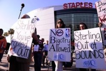 Apr 29, 2014; Los Angeles, CA, USA; Demonstrators hold up signs in front of Staples Center demanding the sale of the Los Angeles Clippers prior to game five of the first round of the 2014 NBA Playoffs. The NBA handed down a lifetime ban on Clippers owner 