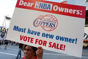 LOS ANGELES, CA -  APRIL 29:   Susan Wright holds a sign protesting racist comments made by L.A. Clippers owner Donald Sterling outside Staples Center before a playoff game on April 29, 2014 in Los Angeles, California. Clippers owner Donald Sterling was b