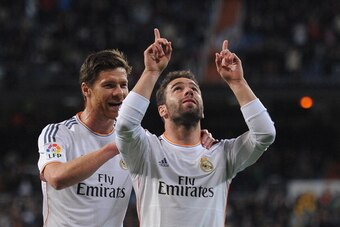 MADRID, SPAIN - APRIL 26:  Daniel Carvajal (R) of Real Madrid CF celebrates beside Xabi Alonso after scoring Real's 4th goal from a free kick during the La Liga match between Real Madrid CF and CA Osasuna at the Santiago Bernabeu stadium on April 26, 2014