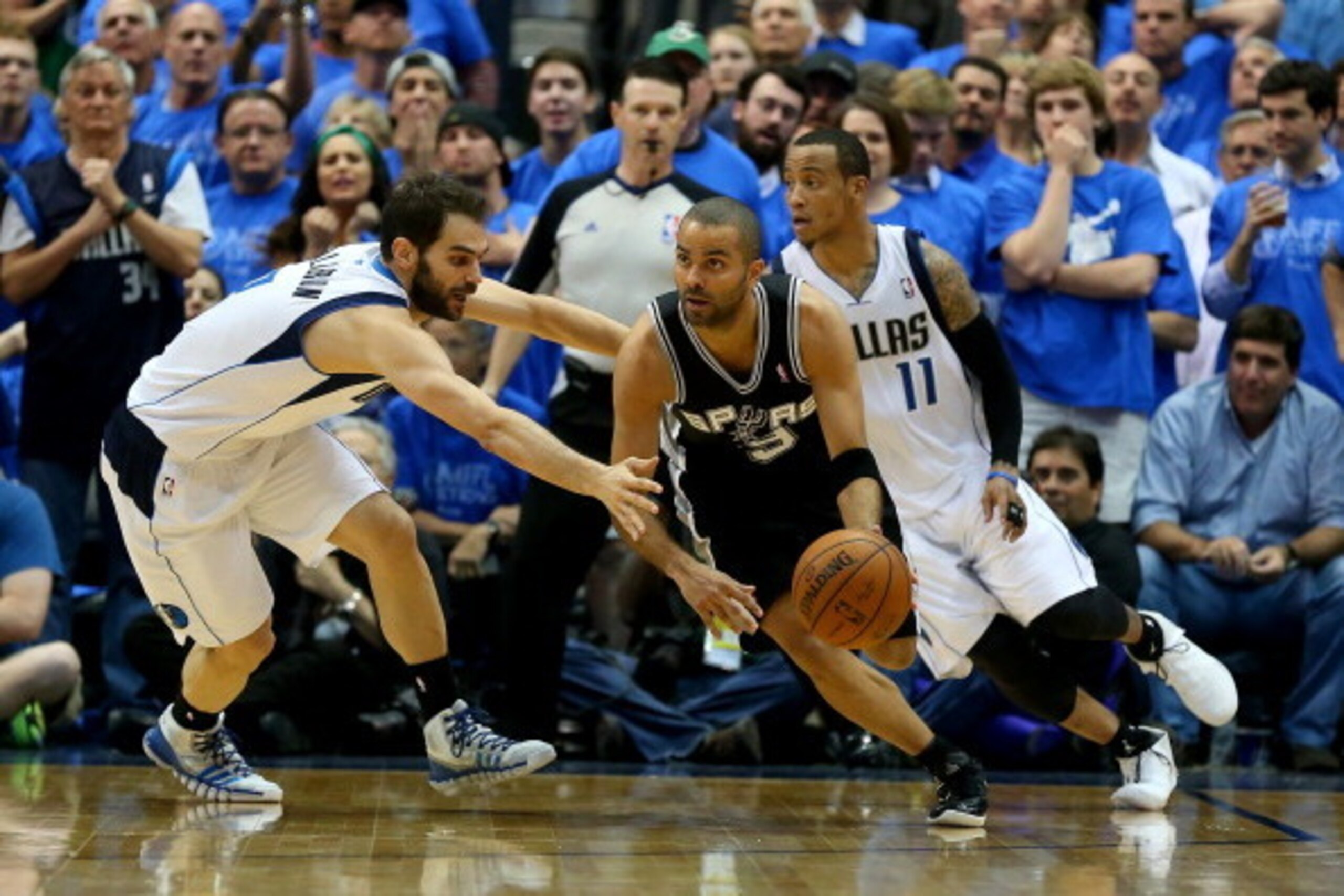 DALLAS, TX - APRIL 28:  Tony Parker #9 of the San Antonio Spurs dribbles the ball against Jose Calderon #8 of the Dallas Mavericks in Game Four of the Western Conference Quarterfinals during the 2014 NBA Playoffs at American Airlines Center on April 28, 2