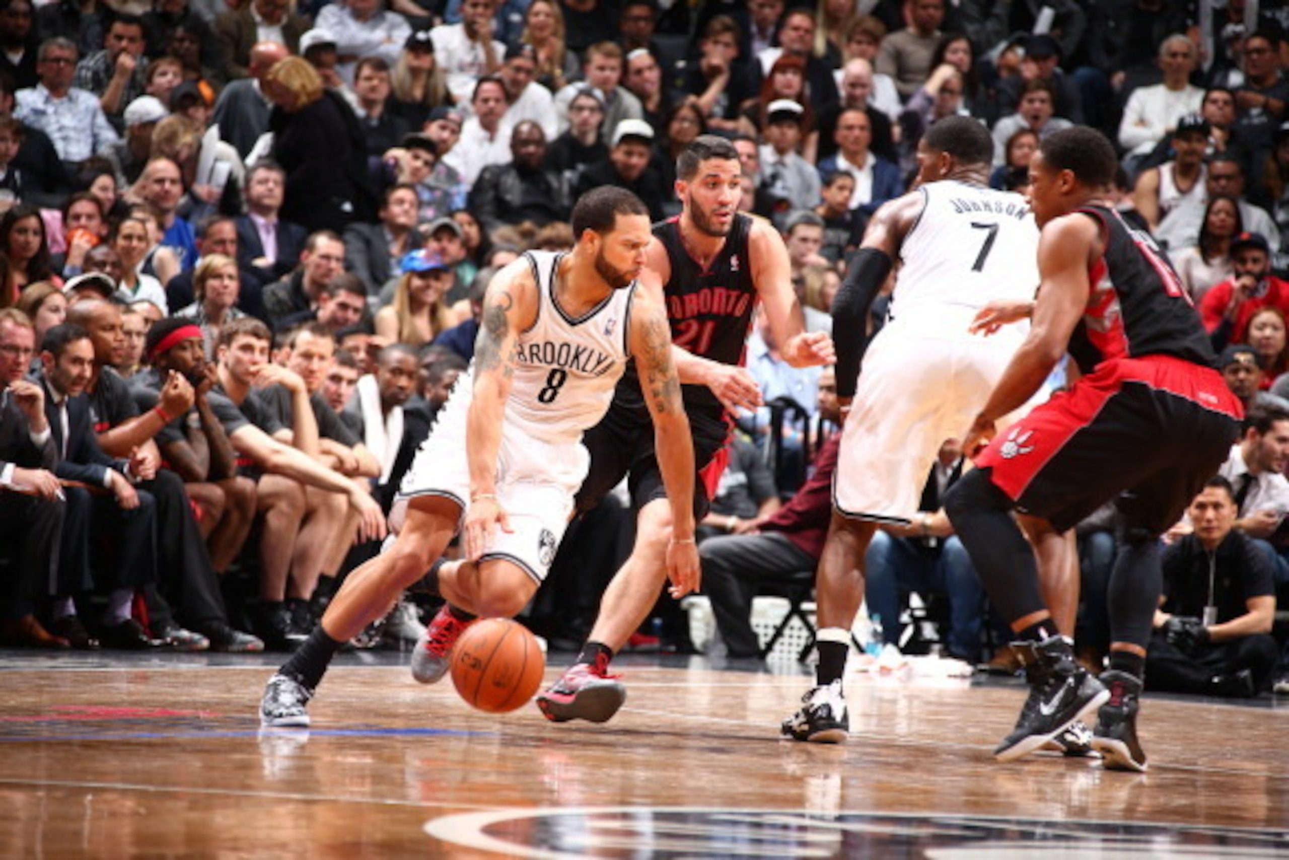 BROOKLYN, NY - APRIL 25: Deron Williams #8 of the Brooklyn Nets drives against the Toronto Raptors in Game Three of the Eastern Conference Quarterfinals during the NBA Playoffs on April 25, 2014 at the Barclays Center in Brooklyn, New York. NOTE TO USER: 