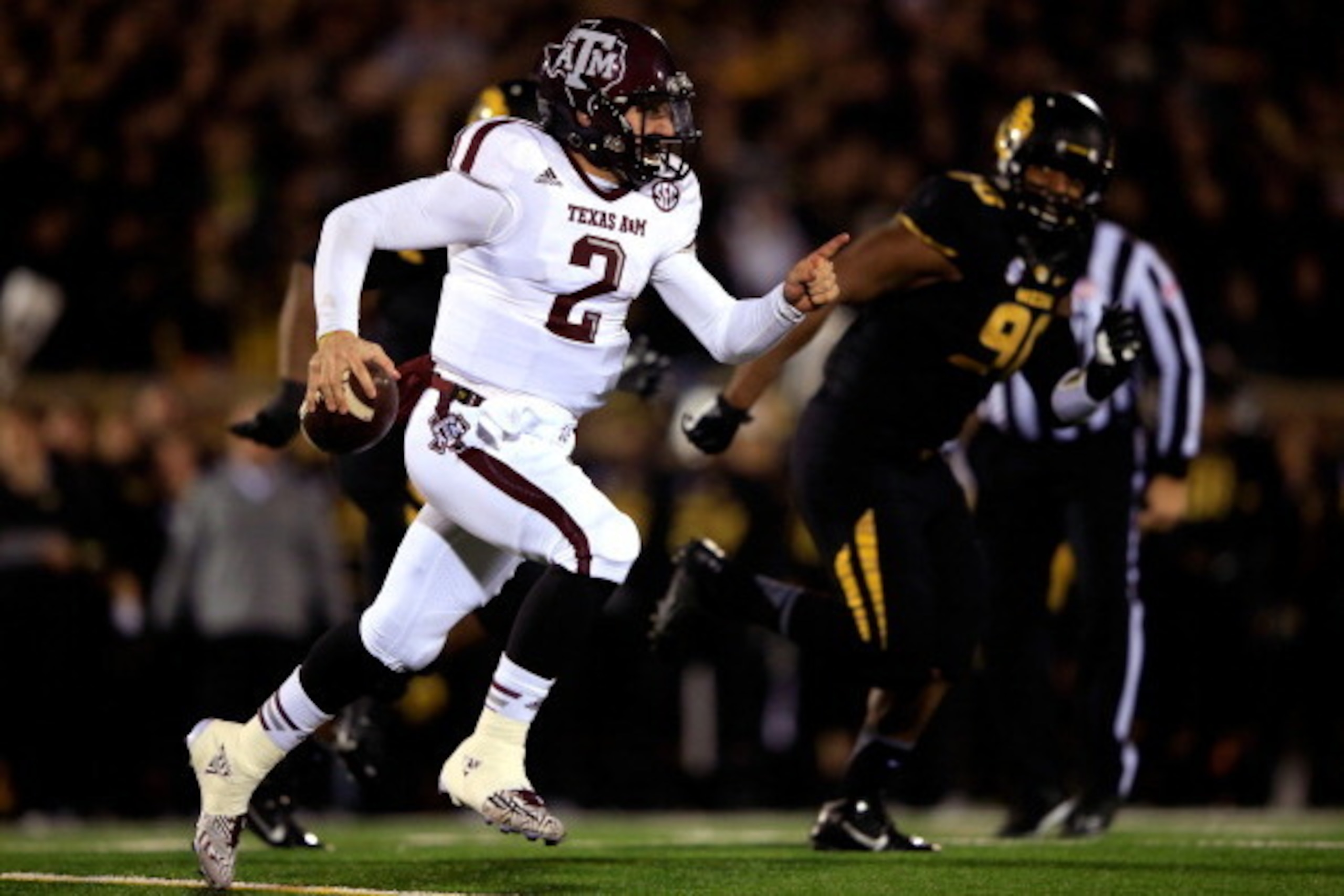COLUMBIA, MO - NOVEMBER 30:  Quarterback Johnny Manziel #2 of the Texas A&M Aggies scrambles as defensive lineman Harold Brantley #90 of the Missouri Tigers chases during the game on November 30, 2013 in Columbia, Missouri.  (Photo by Jamie Squire/Getty I