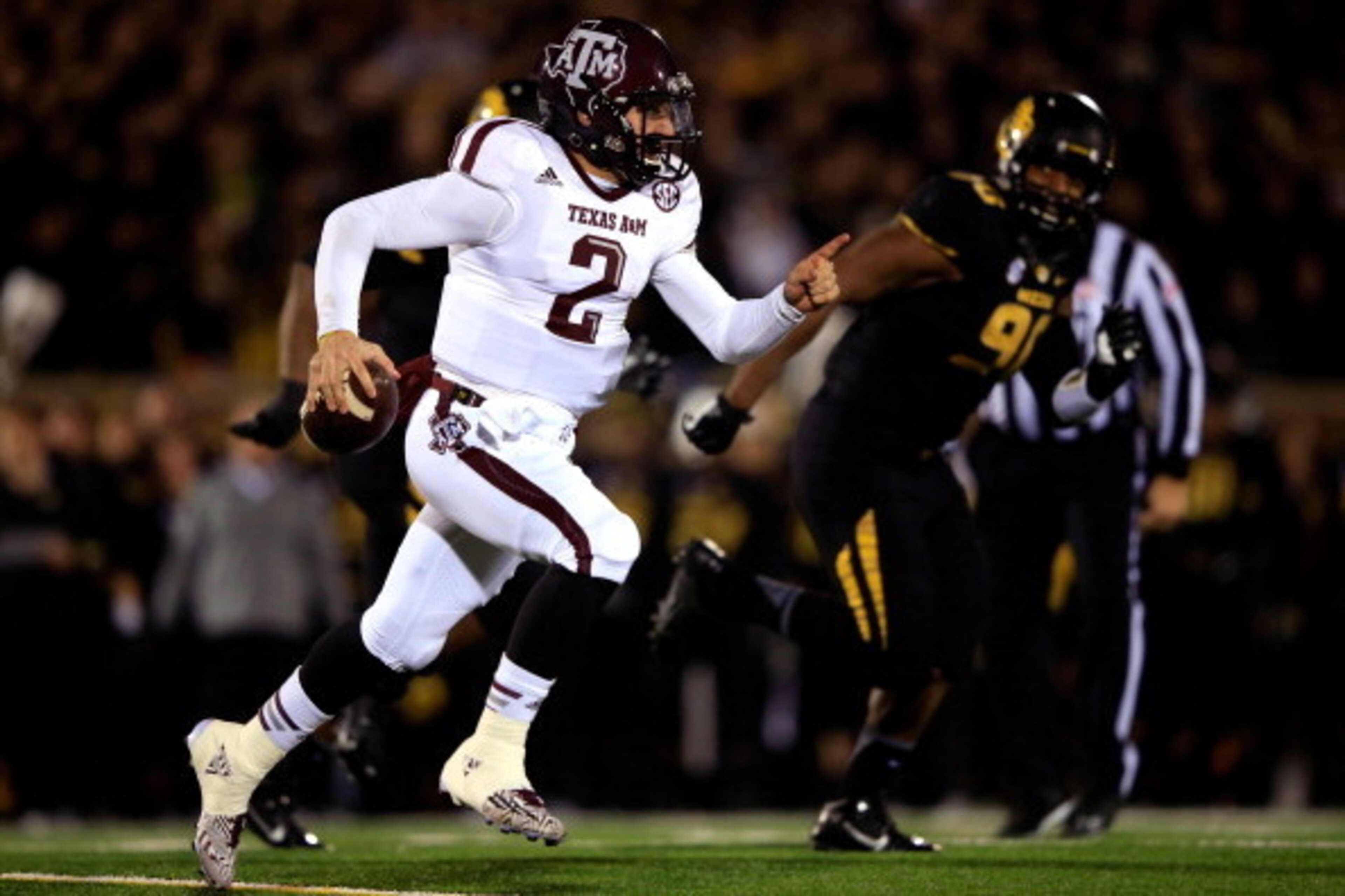 COLUMBIA, MO - NOVEMBER 30:  Quarterback Johnny Manziel #2 of the Texas A&M Aggies scrambles as defensive lineman Harold Brantley #90 of the Missouri Tigers chases during the game on November 30, 2013 in Columbia, Missouri.  (Photo by Jamie Squire/Getty I