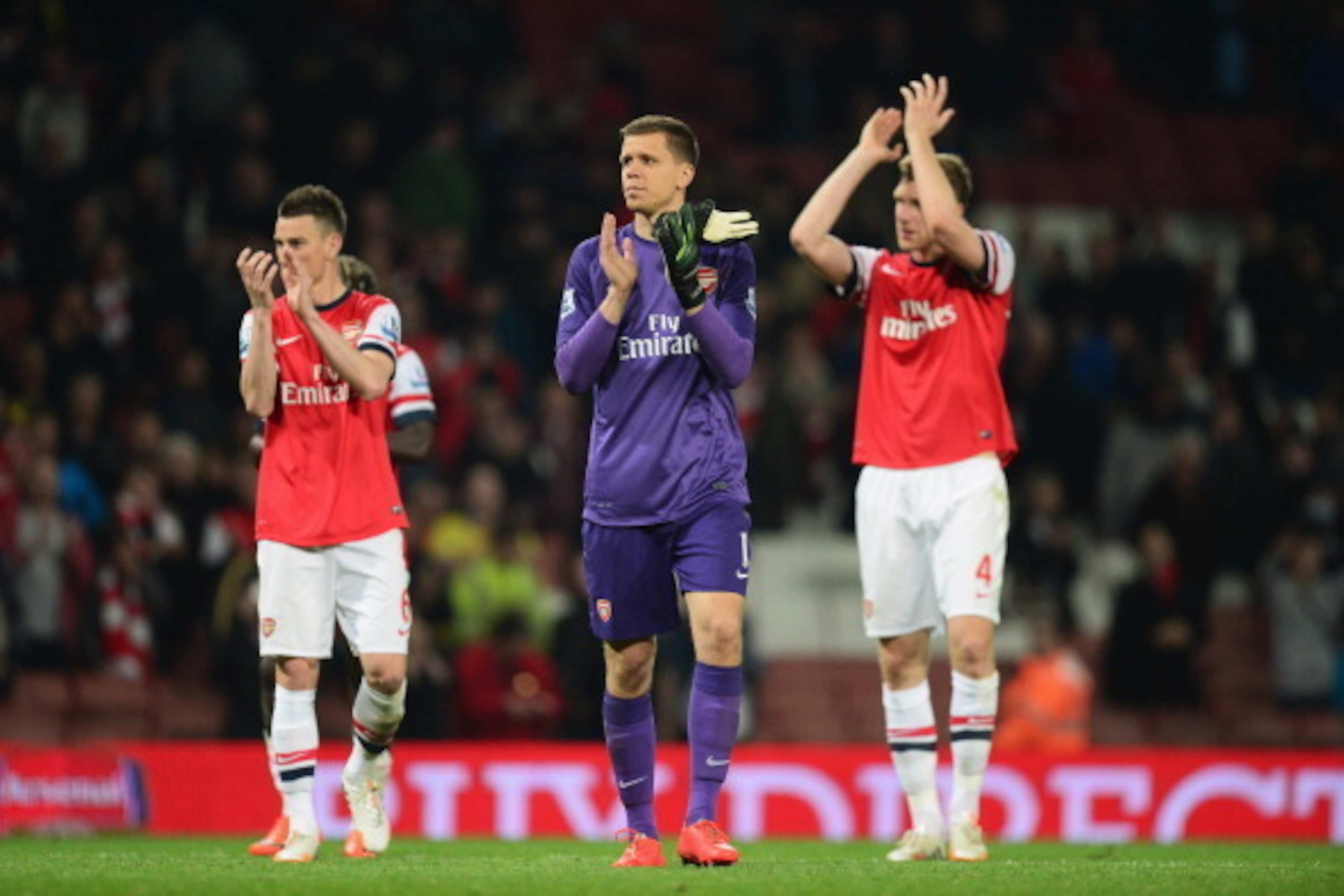 LONDON, ENGLAND - APRIL 28:  (L-R) Laurent Koscielny, Wojciech Szczesny and Per Mertesacker of Arsenal applaud the crowd after victory during the Barclays Premier League match between Arsenal and Newcastle United at Emirates Stadium on April 28, 2014 in L