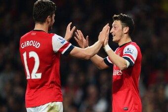 LONDON, ENGLAND - APRIL 28:  Mesut Oezil of Arsenal (11) celebrates with Olivier Giroud as he scores their second goal during the Barclays Premier League match between Arsenal and Newcastle United at Emirates Stadium on April 28, 2014 in London, England. 