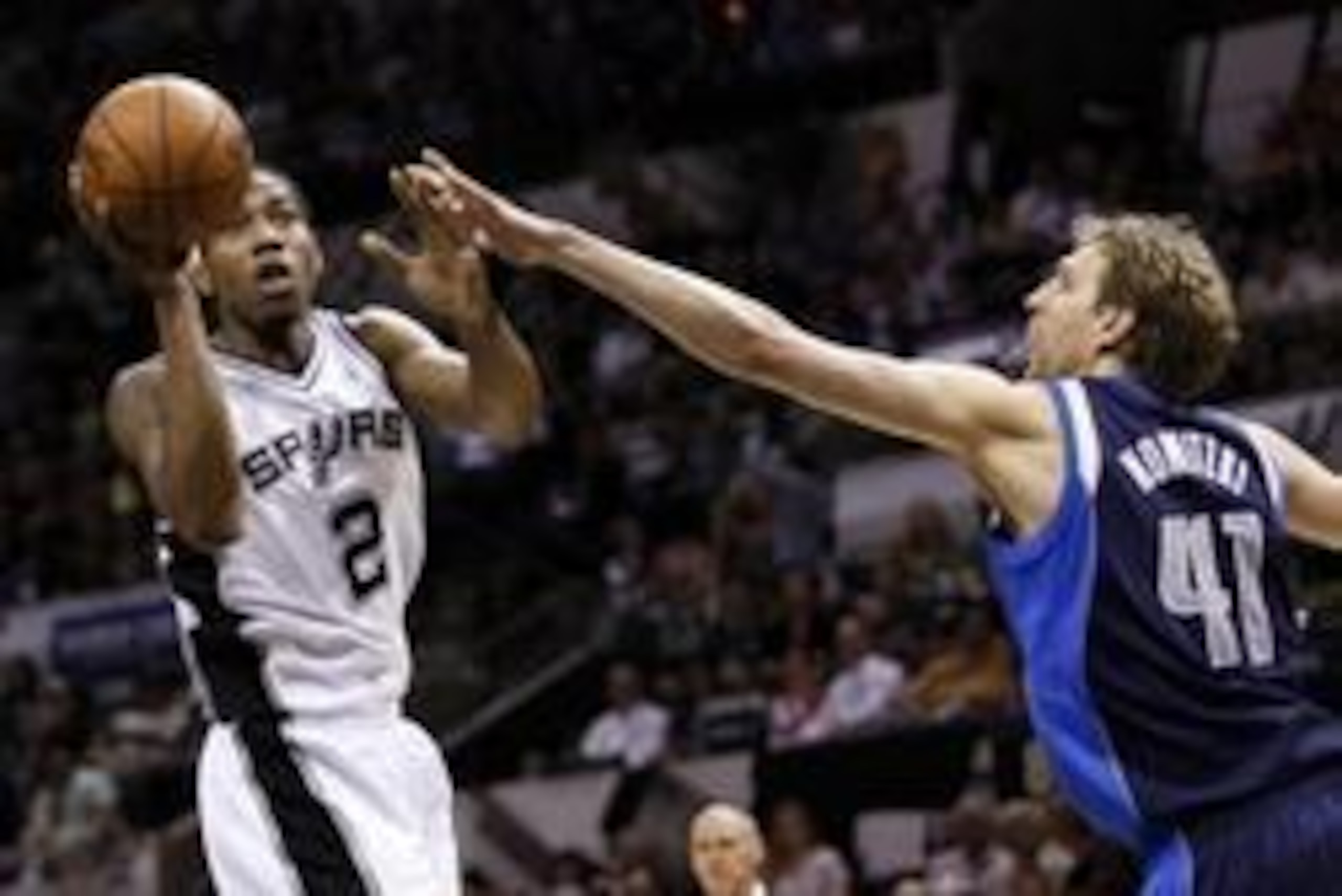 uApr 30, 2014; San Antonio, TX, USA; San Antonio Spurs forward Kawhi Leonard (2) shoots as Dallas Mavericks player Dirk Nowitzki (41) defends in game five of the first round of the 2014 NBA Playoffs at AT&T Center. The Spurs won 109-103. Mandatory Credit: