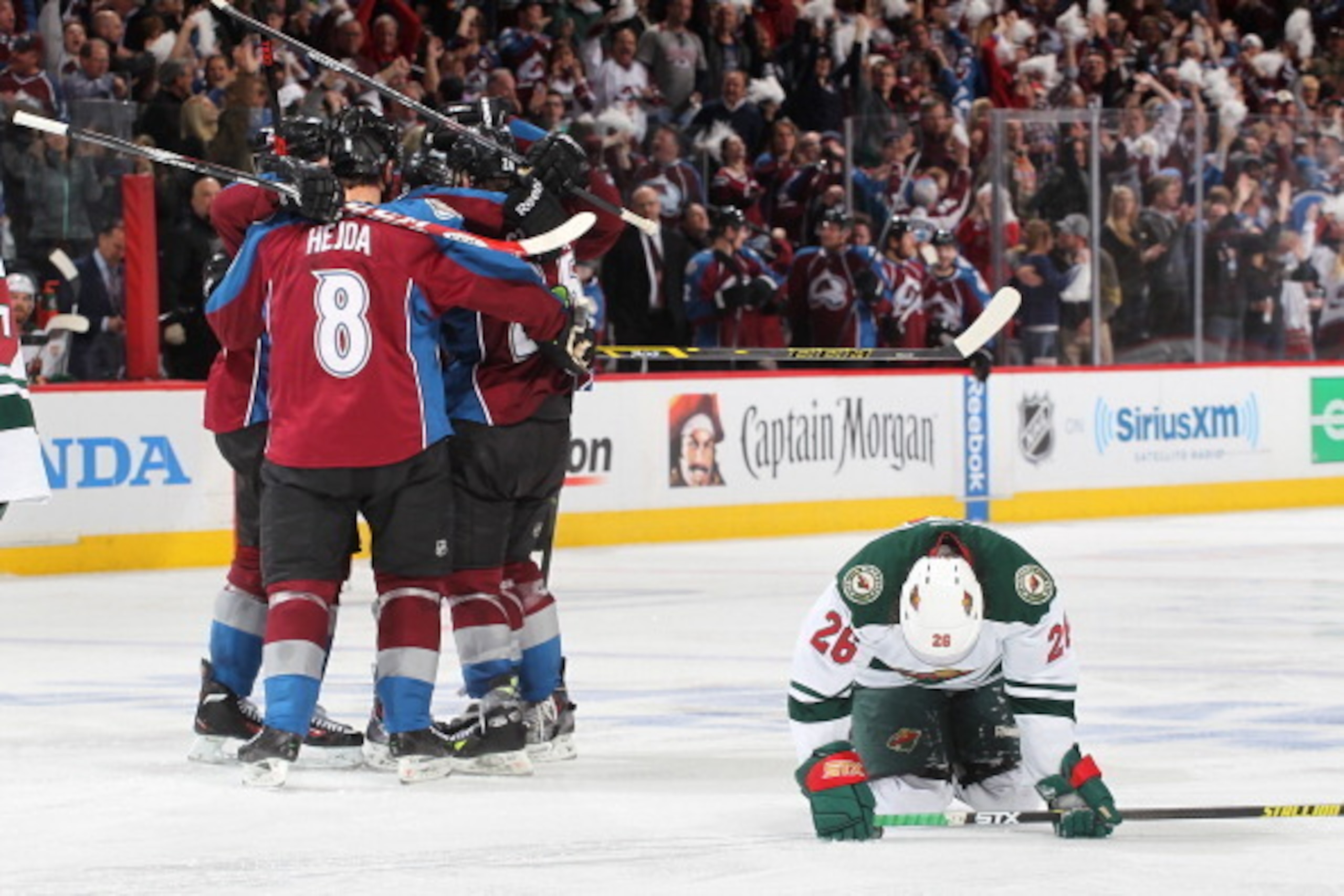 DENVER, CO - APRIL 30: Jan Hejda #8 and other members of the Colorado Avalanche celebrate a goal as Matt Moulson #26 of the Minnesota Wild reacts in Game Seven of the First Round of the 2014 Stanley Cup Playoffs at the Pepsi Center on April 30, 2014 in De