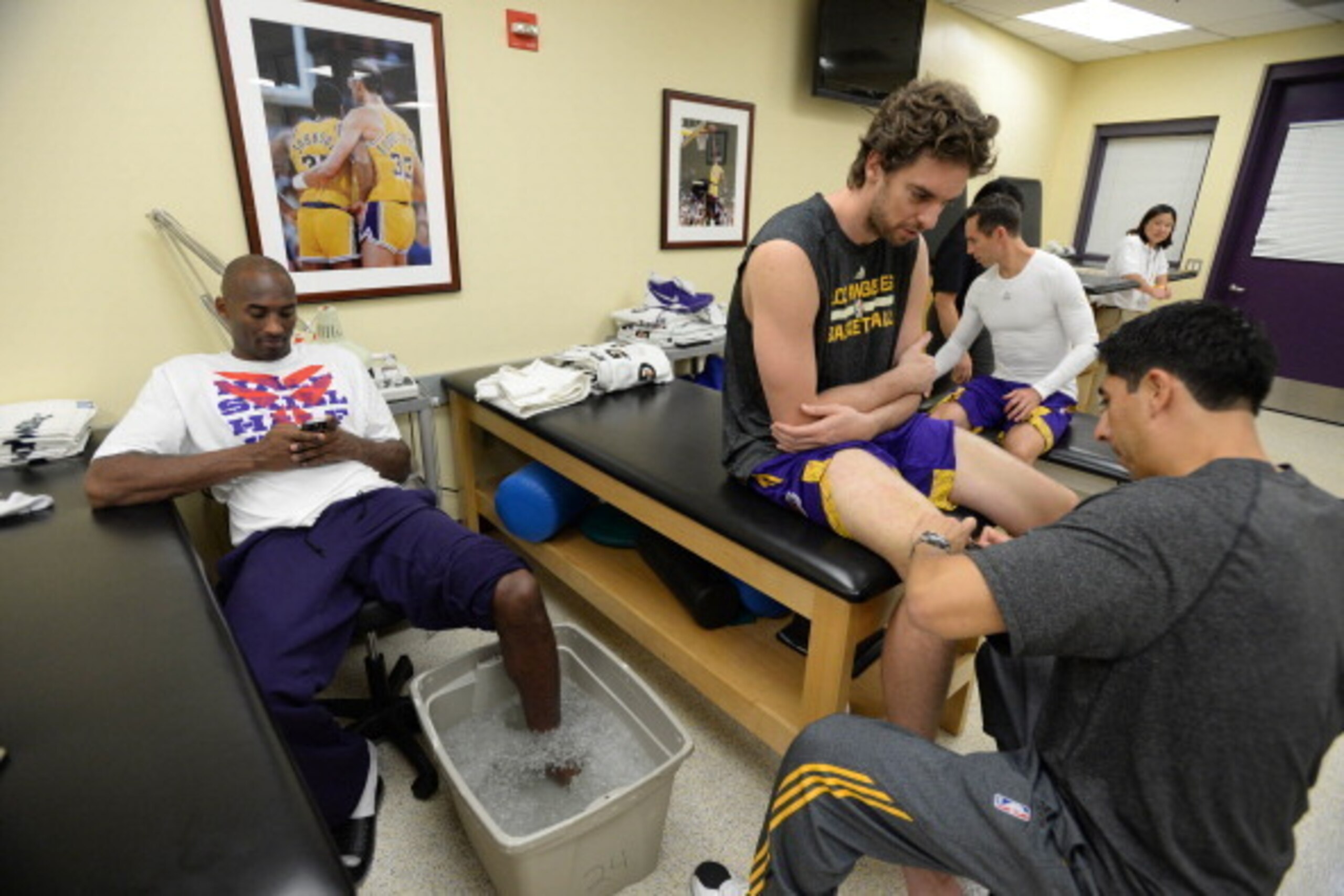 LOS ANGELES, CA - OCTOBER 22: Kobe Bryant #24, Pau Gasol #16, and Steve Nash #10 of the Los Angeles Lakers sit in the training room before facing the Utah Jazz at Staples Center on October 22, 2013 in Los Angeles, California. NOTE TO USER: User expressly 