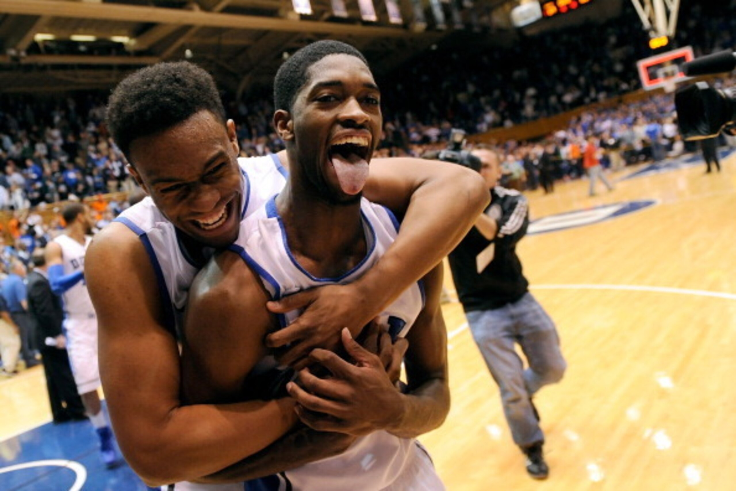 DURHAM, NC - JANUARY 13:  Jabari Parker #1 and Amile Jefferson #21 of the Duke Blue Devils celebrate as they leave the floor following a last-second win over the Virginia Cavaliers at Cameron Indoor Stadium on January 13, 2014 in Durham, North Carolina. D