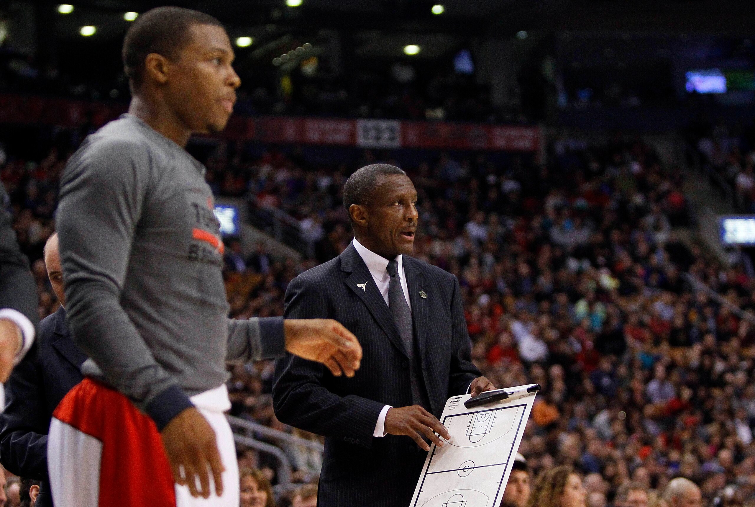 Apr 14, 2014; Toronto, Ontario, CAN; Toronto Raptors guard Kyle Lowry (left) and Toronto Raptors head coach Dwane Casey during a break against the Milwaukee Bucks at the Air Canada Centre. Toronto defeated Milwaukee 110-100. Mandatory Credit: John E. Soko