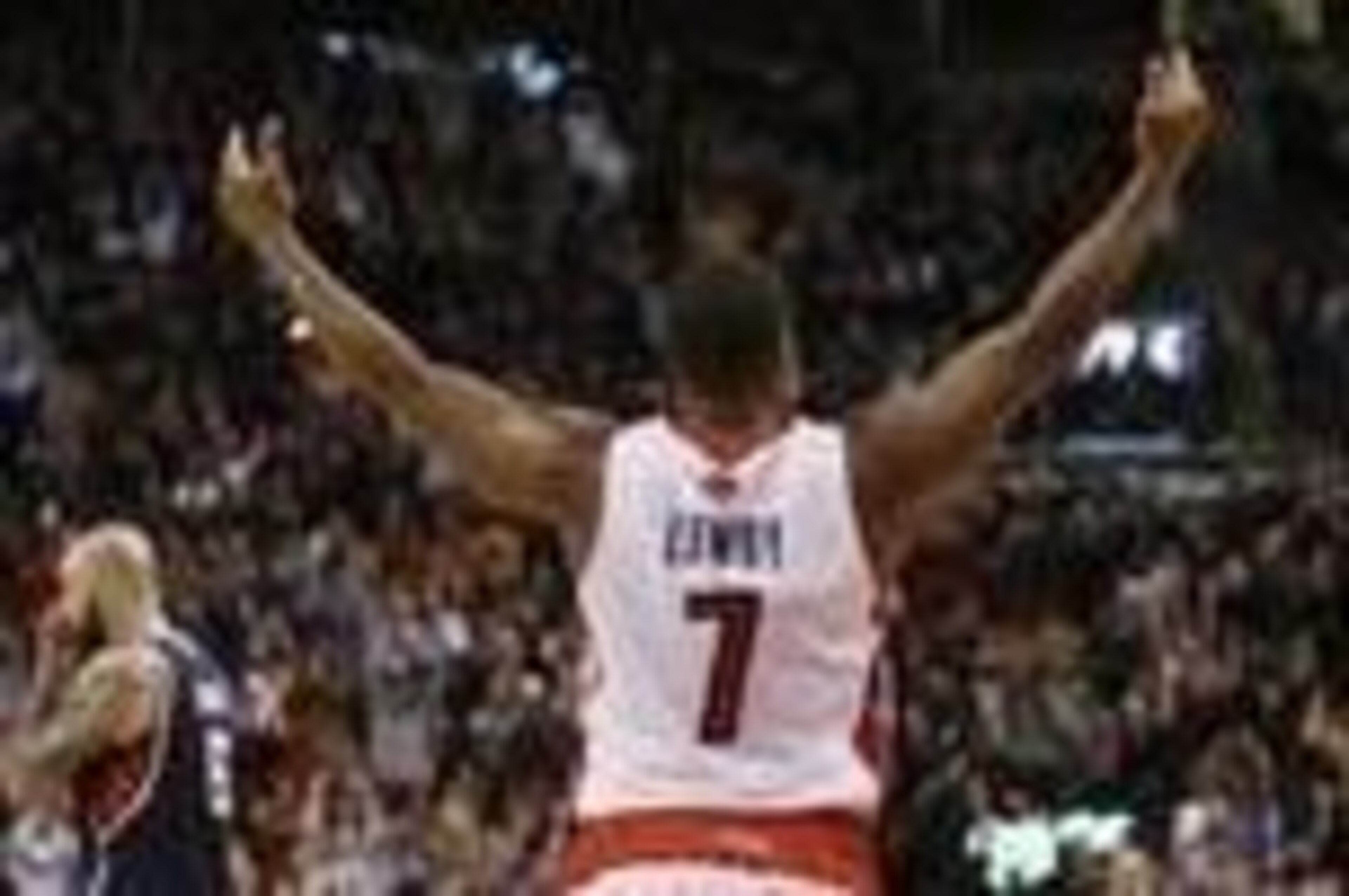 Mar 23, 2014; Toronto, Ontario, CAN; Toronto Raptors guard Kyle Lowry (7) celebrates a win as Atlanta Hawks center Pero Antic (6) walks off the court at the Air Canada Centre. Toronto defeated Atlanta 96-86. Mandatory Credit: John E. Sokolowski-USA TODAY