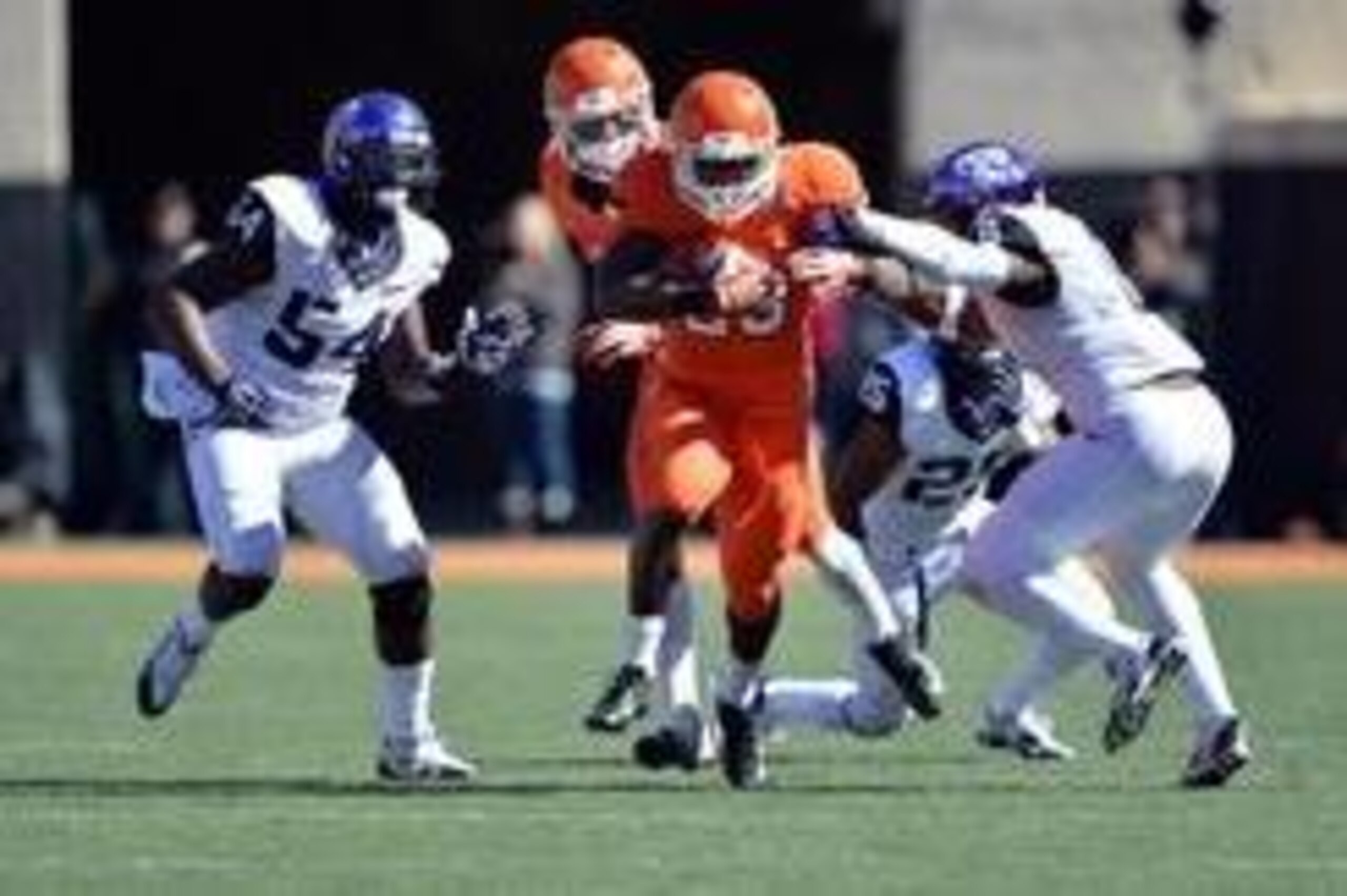 Oct 19, 2013; Stillwater, OK, USA; Oklahoma State Cowboys running back Rennie Childs (23) rushes through Texas Christian Horned Frogs defenders Elisha Olabode (6) and Marcus Mallet  (54) during the second half at Boone Pickens Stadium. Oklahoma State won 