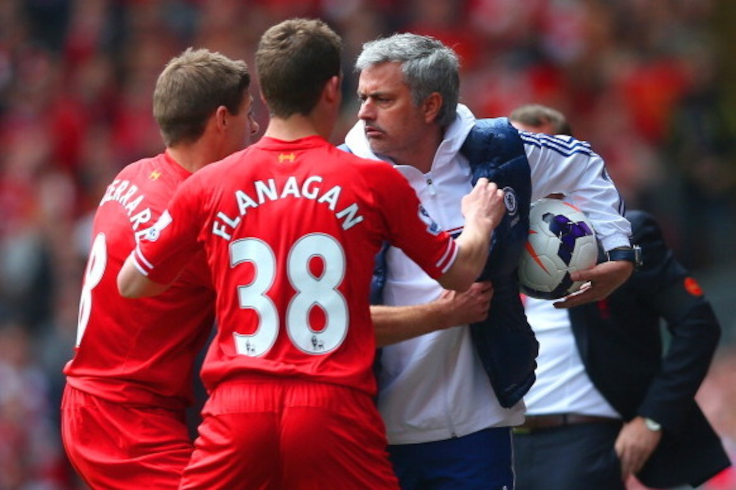 LIVERPOOL, ENGLAND - APRIL 27: (EDITORS NOTE: Retransmission of image 487057275 with alternate crop.) Steven Gerrard and Jon Flanagan of Liverpool have words with Jose Mourinho manager of Chelsea as he holds onto the ball during the Barclays Premier Leagu