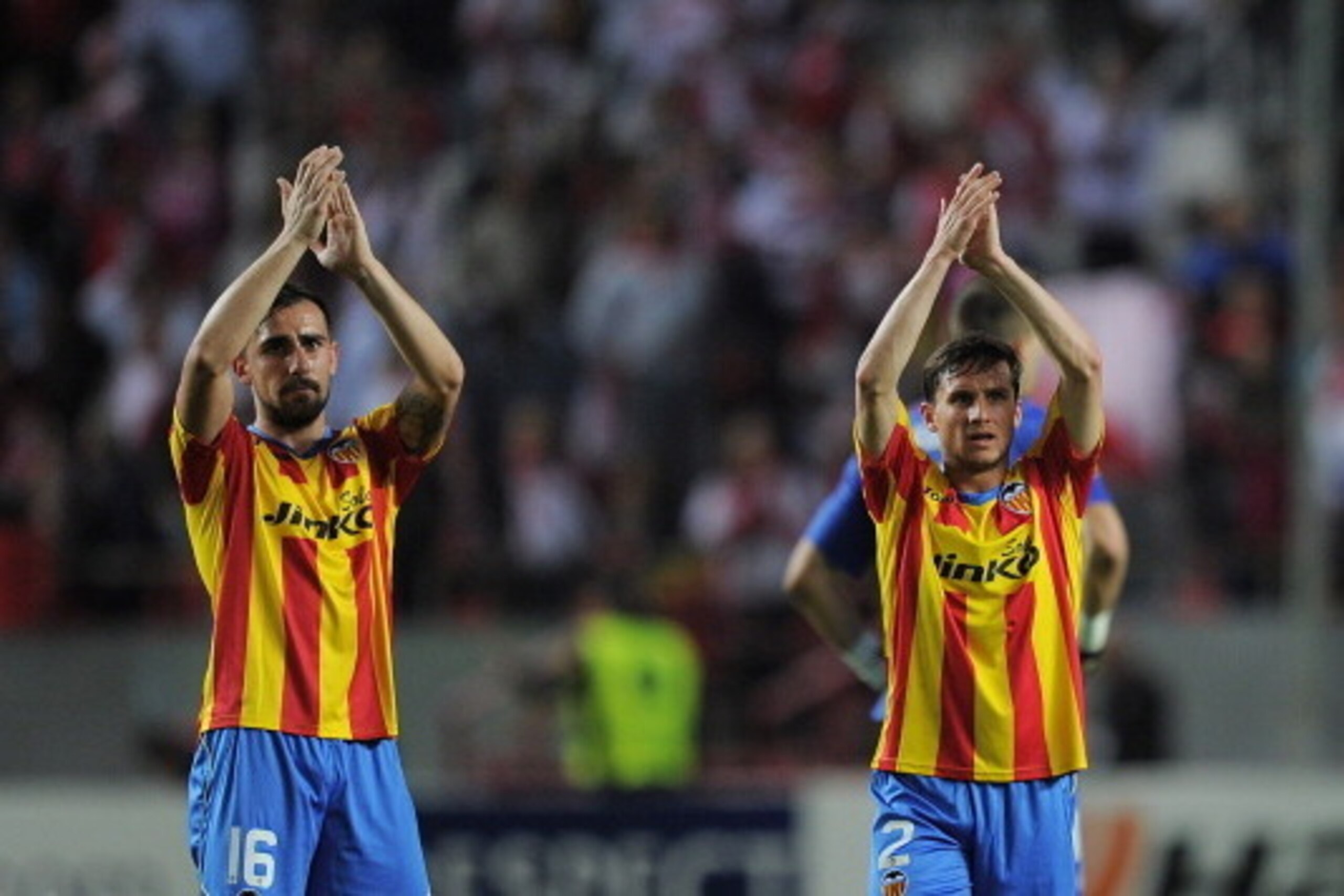 SEVILLE, SPAIN - APRIL 24:  Pablo Piatti (R) and Paco Alcacer of Valencia CF applaud their fans after losing 2-0 to Sevilla FC in the UEFA Europa League Semi Final first leg match between Sevilla FC and Valencia CF at Estadio Ramon Sanchez Pizjuan on Apri