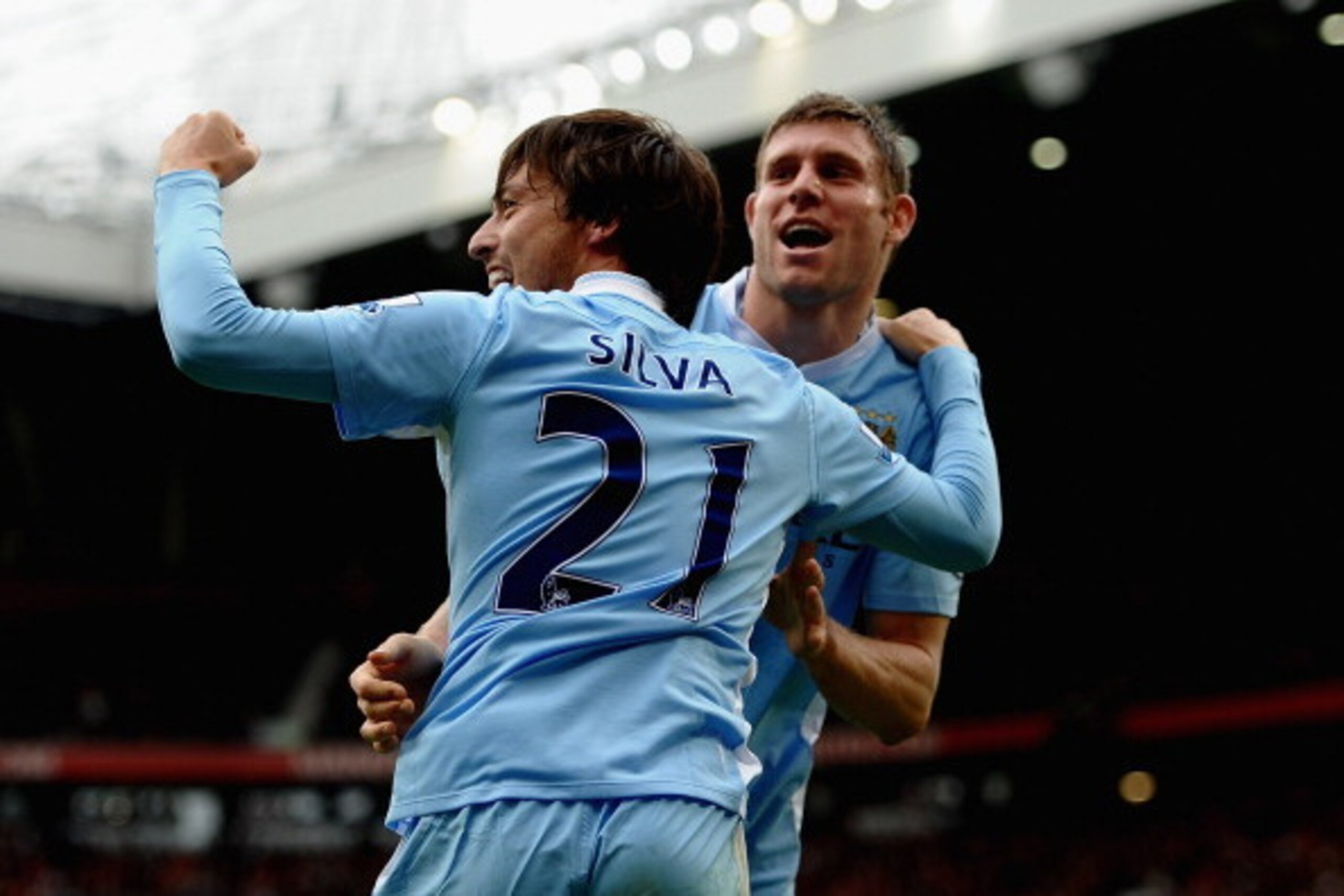 MANCHESTER, ENGLAND - OCTOBER 23: David Silva and James Milner of Manchester City celebrate during the Barclays Premier League match between Manchester United and Manchester City at Old Trafford on October 23, 2011 in Manchester, England. (Photo by Lauren
