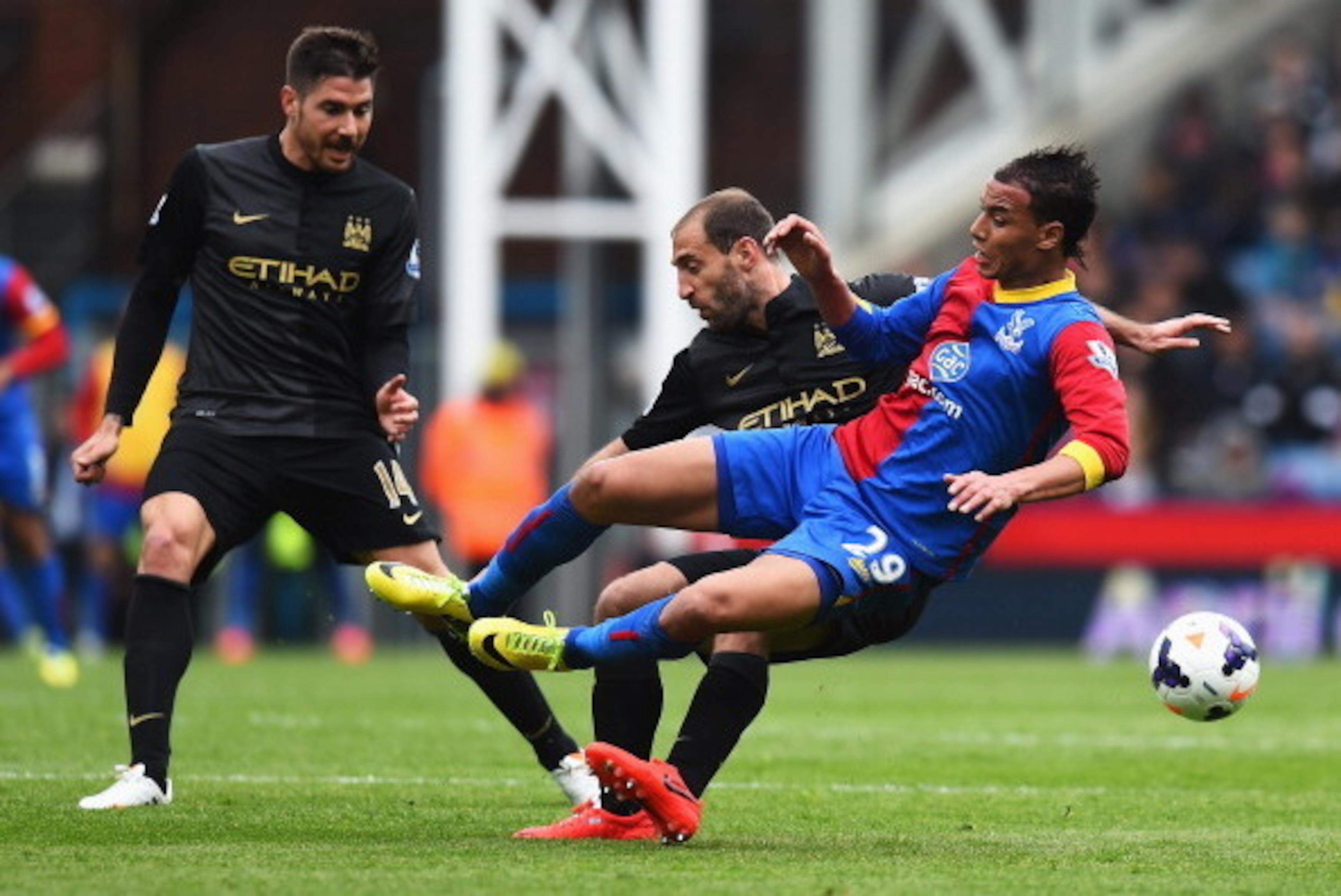 LONDON, ENGLAND - APRIL 27: Marouane Chamakh of Crystal Palace is tackled by Pablo Zabaleta of Manchester City watched by Javi Garcia of Manchester City during the Barclays Premier League match between Crystal Palace and Manchester City at Selhurst Park o