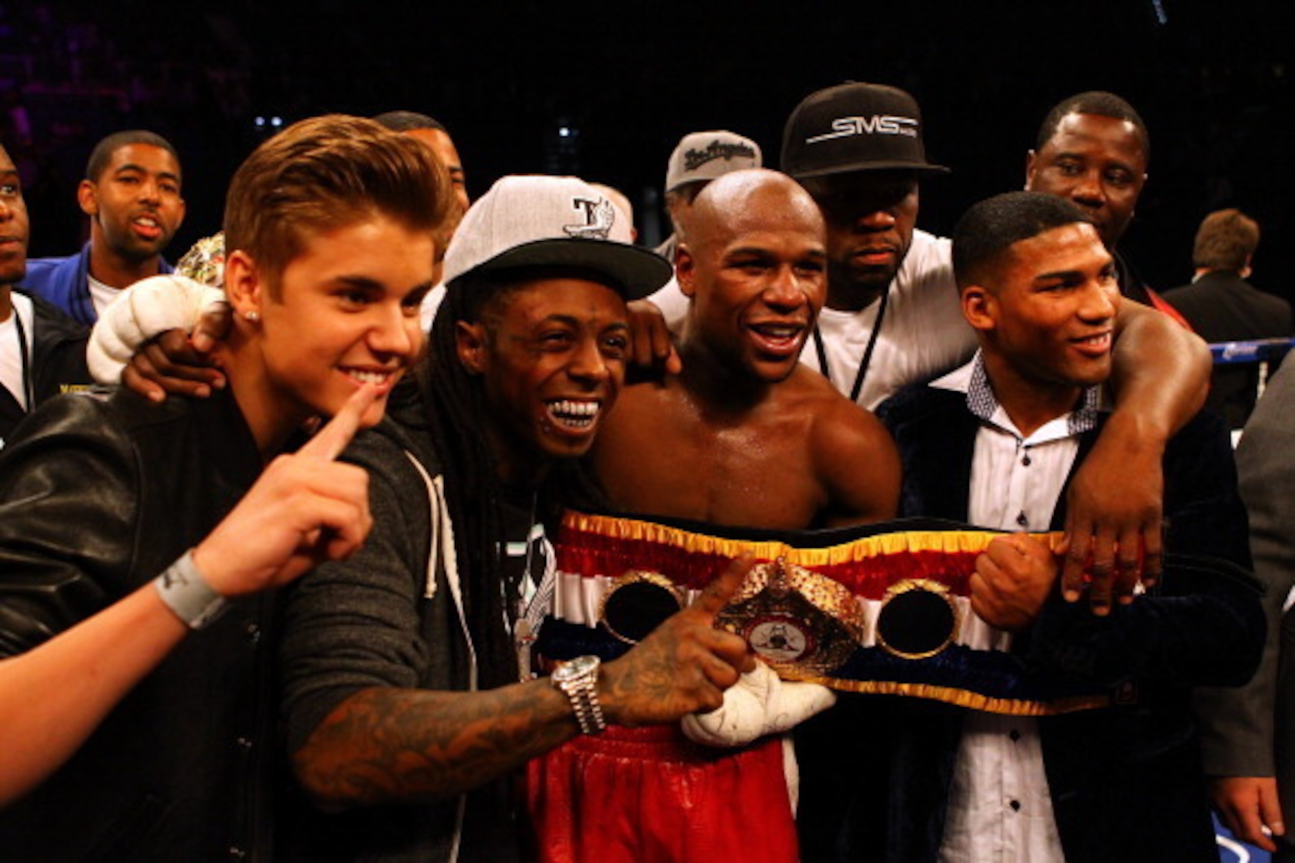 LAS VEGAS, NV - MAY 05:  Singer Justin Bieber, Rapper Lil Wayne, boxer Floyd Mayweather Jr., rapper Curtis '50 Cent' Jackson and Yuriorkis Gamboa pose after Mayweather Jr. defeats Miguel Cotto by unanimous decision in their WBA super welterweight title fi