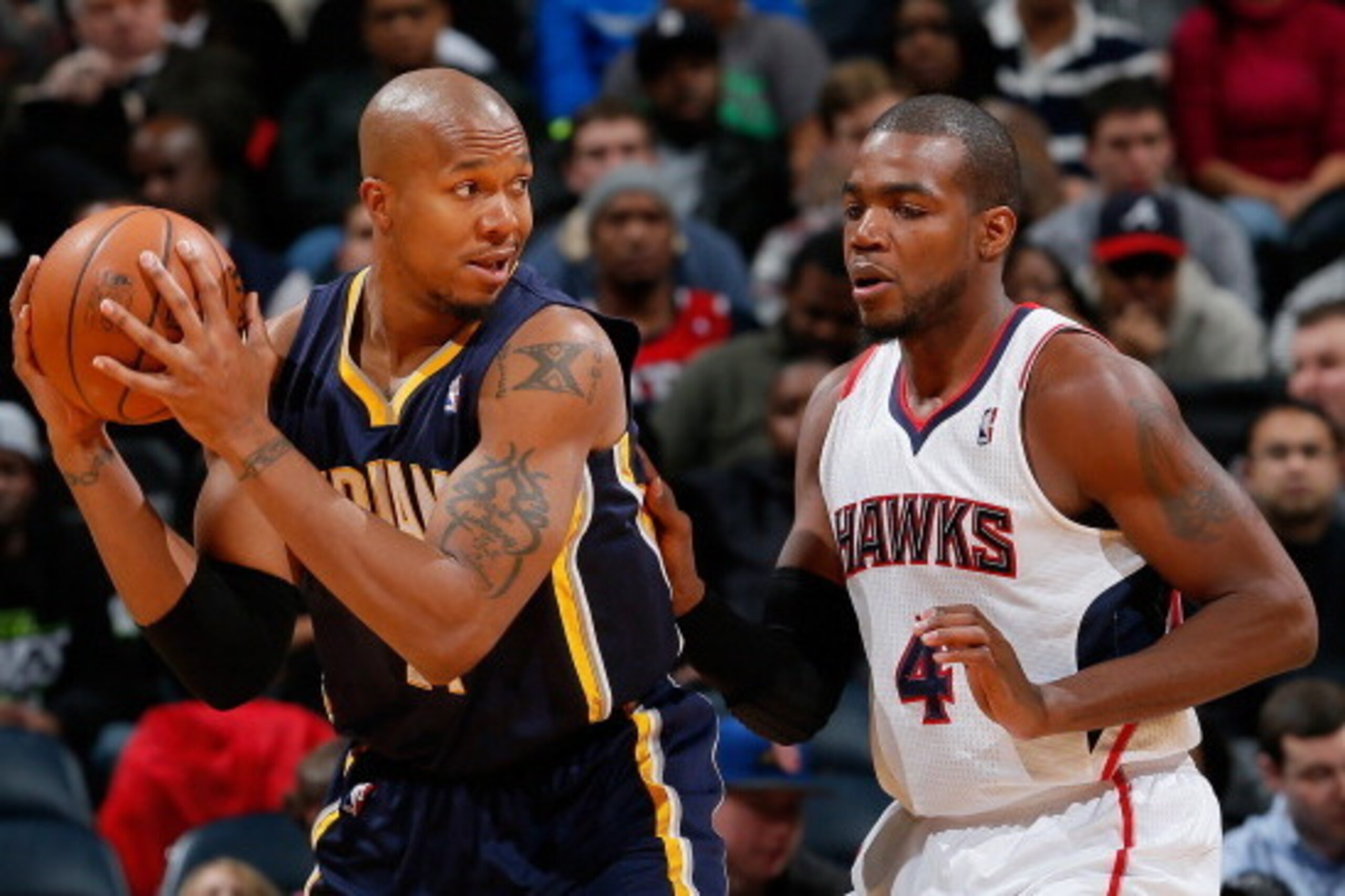 ATLANTA, GA - JANUARY 08:  David West #21 of the Indiana Pacers against Paul Millsap #4 of the Atlanta Hawks at Philips Arena on January 8, 2014 in Atlanta, Georgia.  NOTE TO USER: User expressly acknowledges and agrees that, by downloading and or using t