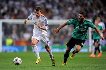 MADRID, SPAIN - MARCH 18:  Gareth Bale of Real Madrid is pursued by Sead Kolasinac of Schalke during the UEFA Champions League Round of 16, second leg match between Real Madrid and FC Schalke 04 at Estadio Santiago Bernabeu on March 18, 2014 in Madrid, Sp