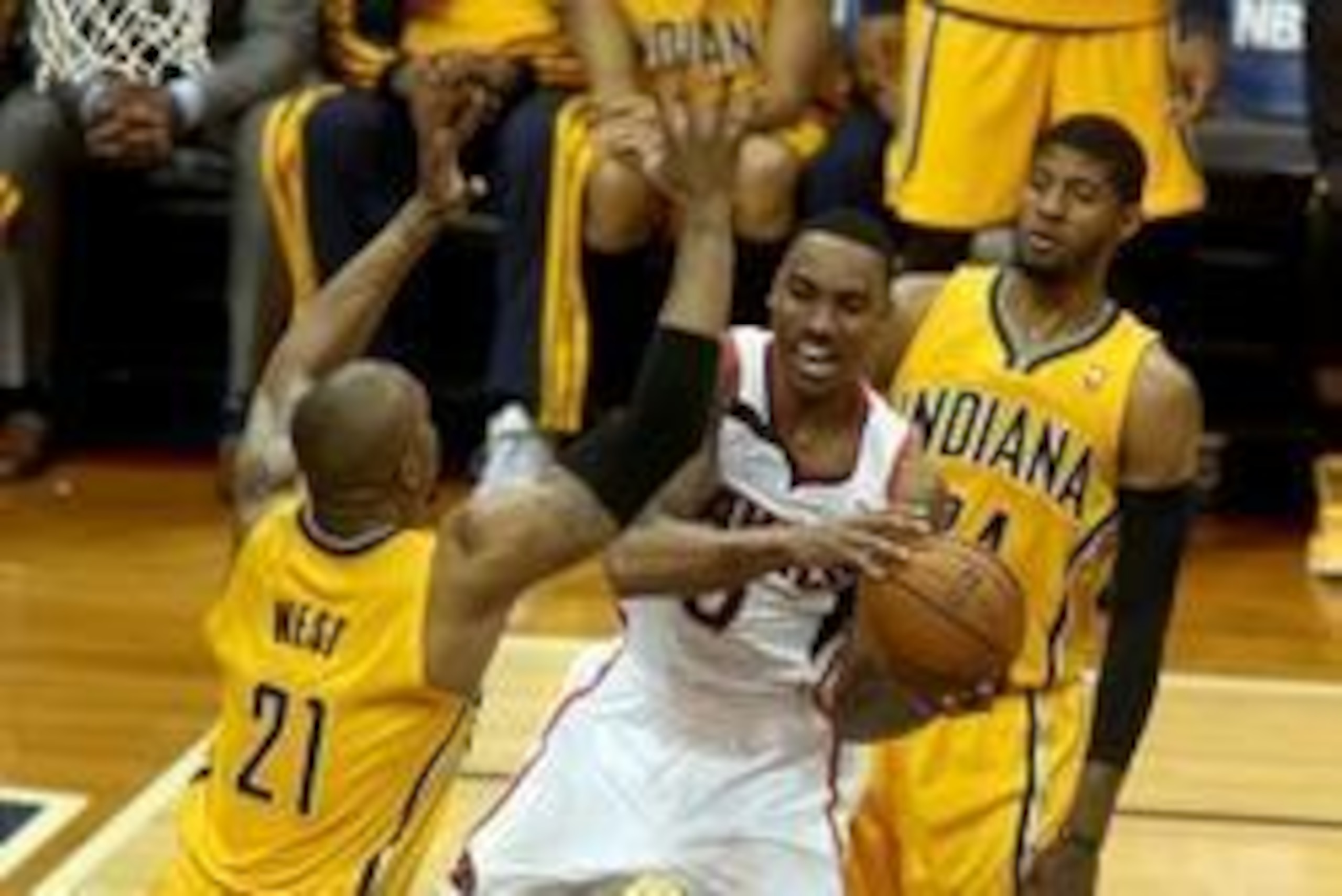May 1, 2014; Atlanta, GA, USA; Atlanta Hawks guard Jeff Teague (0) drives against Indiana Pacers forward David West (21) and forward Paul George (24) in the second quarter of game six of the first round of the 2014 NBA Playoffs at Philips Arena. Mandatory