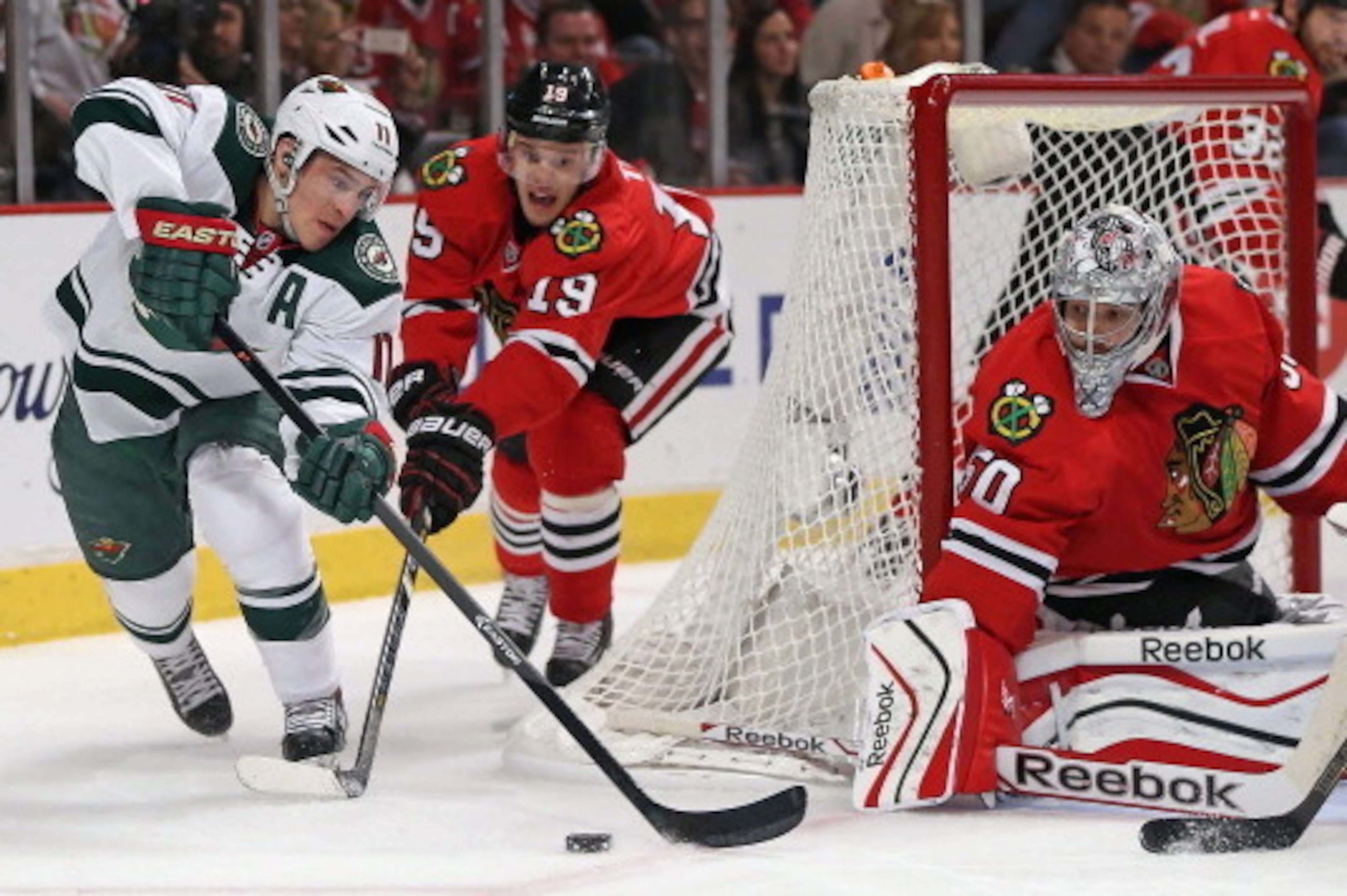 CHICAGO, IL - MAY 02: Nick Parise #11 of the Minnesota Wild tries to get off a shot at Corey Crawford #50 of the Chicago Blackhawks as Jonathan Toews #19 applies pressure in Game One of the Second Round of the 2014 NHL Stanley Cup Playoffs at the United C CHICAGO, IL - MAY 02: Nick Parise #11 of the Minnesota Wild tries to get off a shot at Corey Crawford #50 of the Chicago Blackhawks as Jonathan Toews #19 applies pressure in Game One of the Second Round of the 2014 NHL Stanley Cup Playoffs at the United C