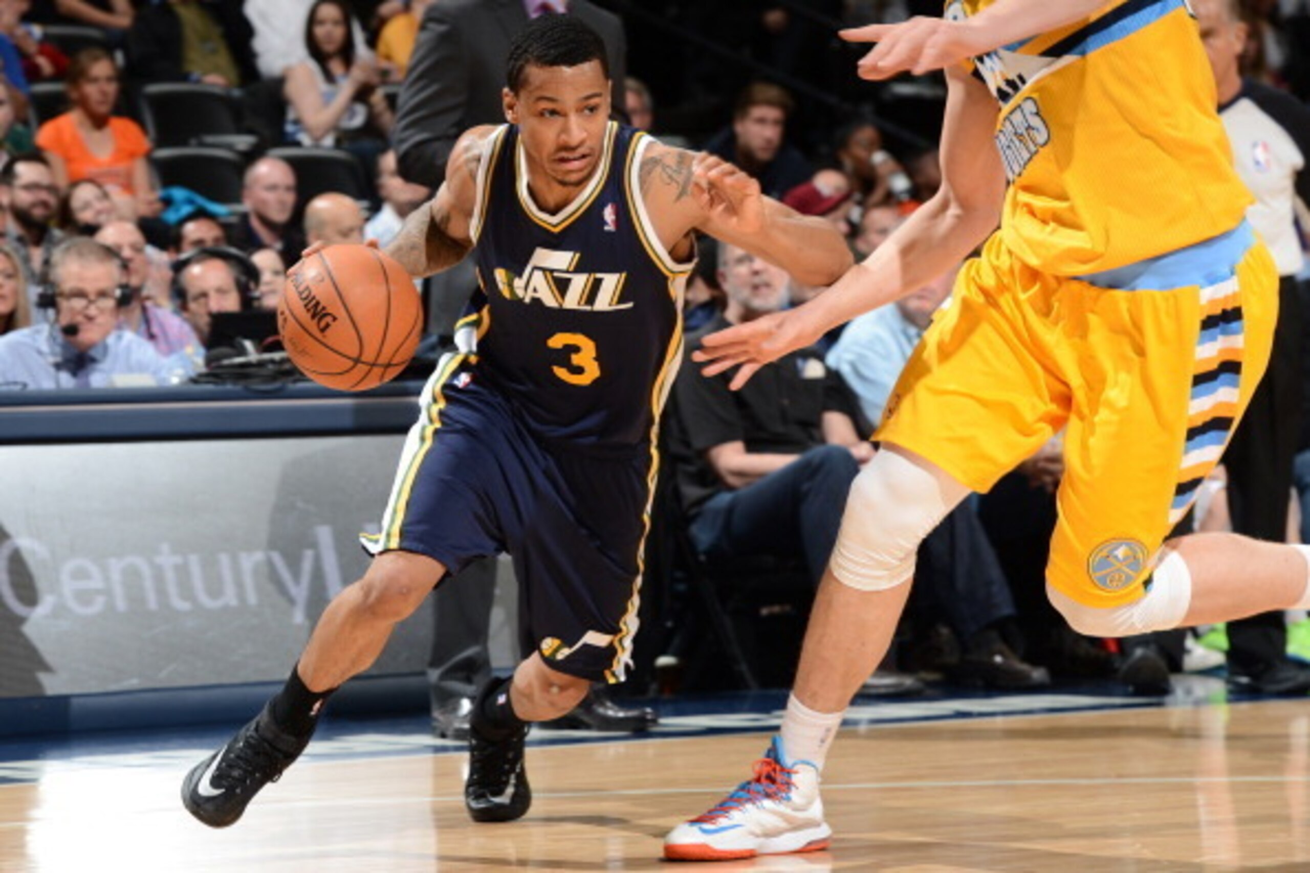 DENVER, CO - APRIL 12: Trey Burke #3 of the Utah Jazz drives against the Denver Nuggets on April 12, 2014 at the Pepsi Center in Denver, Colorado. NOTE TO USER: User expressly acknowledges and agrees that, by downloading and/or using this Photograph, user