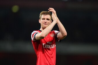 LONDON, ENGLAND - APRIL 28:  Per Mertesacker of Arsenal applauds the crowd after victory during the Barclays Premier League match between Arsenal and Newcastle United at Emirates Stadium on April 28, 2014 in London, England.  (Photo by Jamie McDonald/Gett