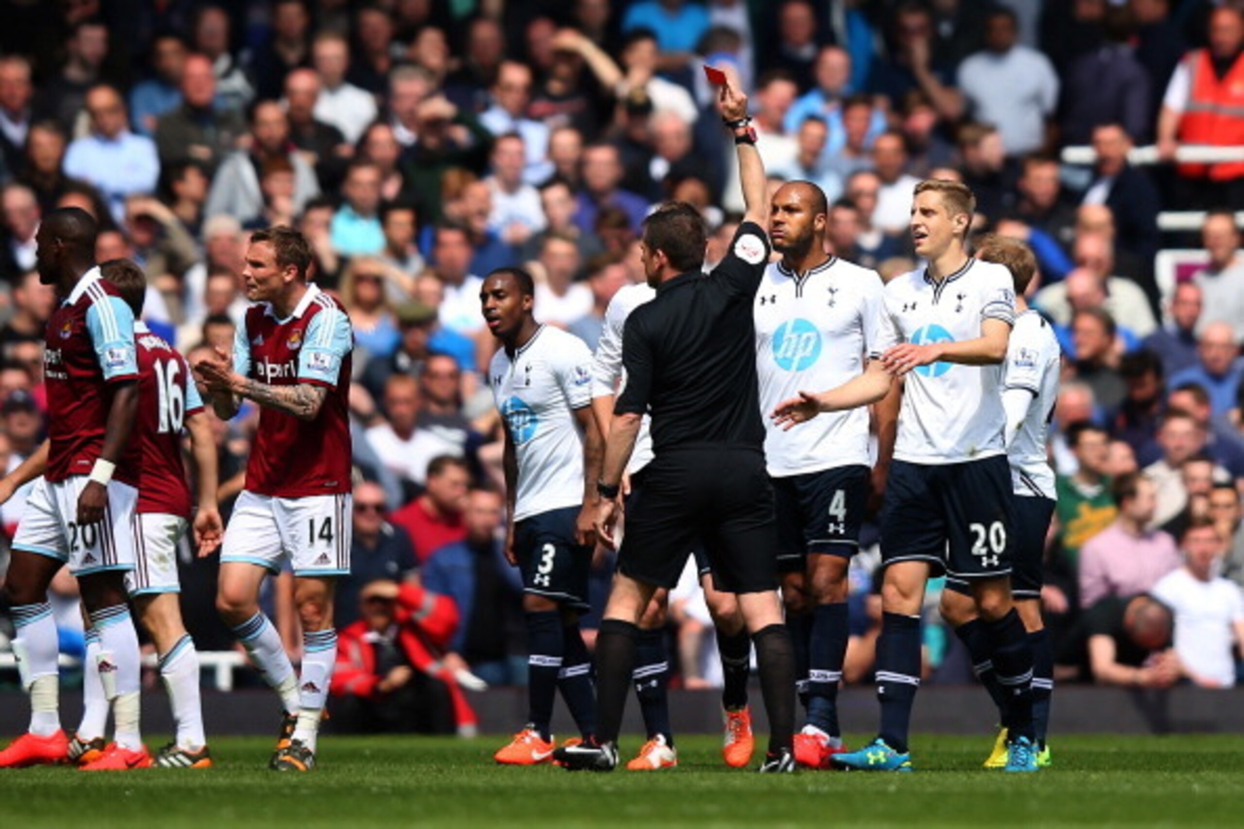 LONDON, ENGLAND - MAY 03:  Referee Phil Dowd shows the red card to Younes Kaboul of Spurs during the Barclays Premier League match between West Ham United and Tottenham Hotspur at Boleyn Ground on May 3, 2014 in London, England.  (Photo by Bryn Lennon/Get