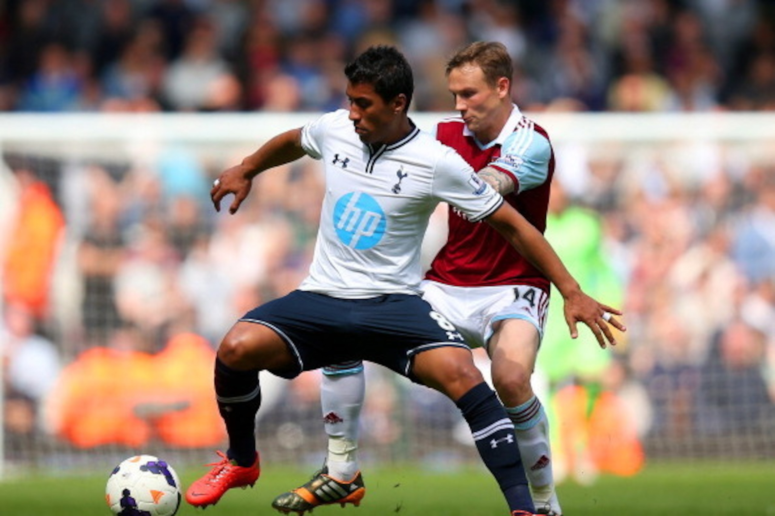 LONDON, ENGLAND - MAY 03:  Paulinho of Spurs is challenged by Matthew Taylor of West Ham during the Barclays Premier League match between West Ham United and Tottenham Hotspur at Boleyn Ground on May 3, 2014 in London, England.  (Photo by Bryn Lennon/Gett