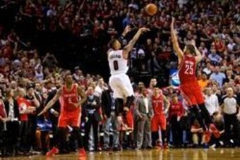 May 2, 2014; Portland, OR, USA; Portland Trail Blazers guard Damian Lillard (0) makes a three pointer at the buzzer over Houston Rockets forward Chandler Parsons (25) to win the game during the fourth quarter in game six of the first round of the 2014 NBA