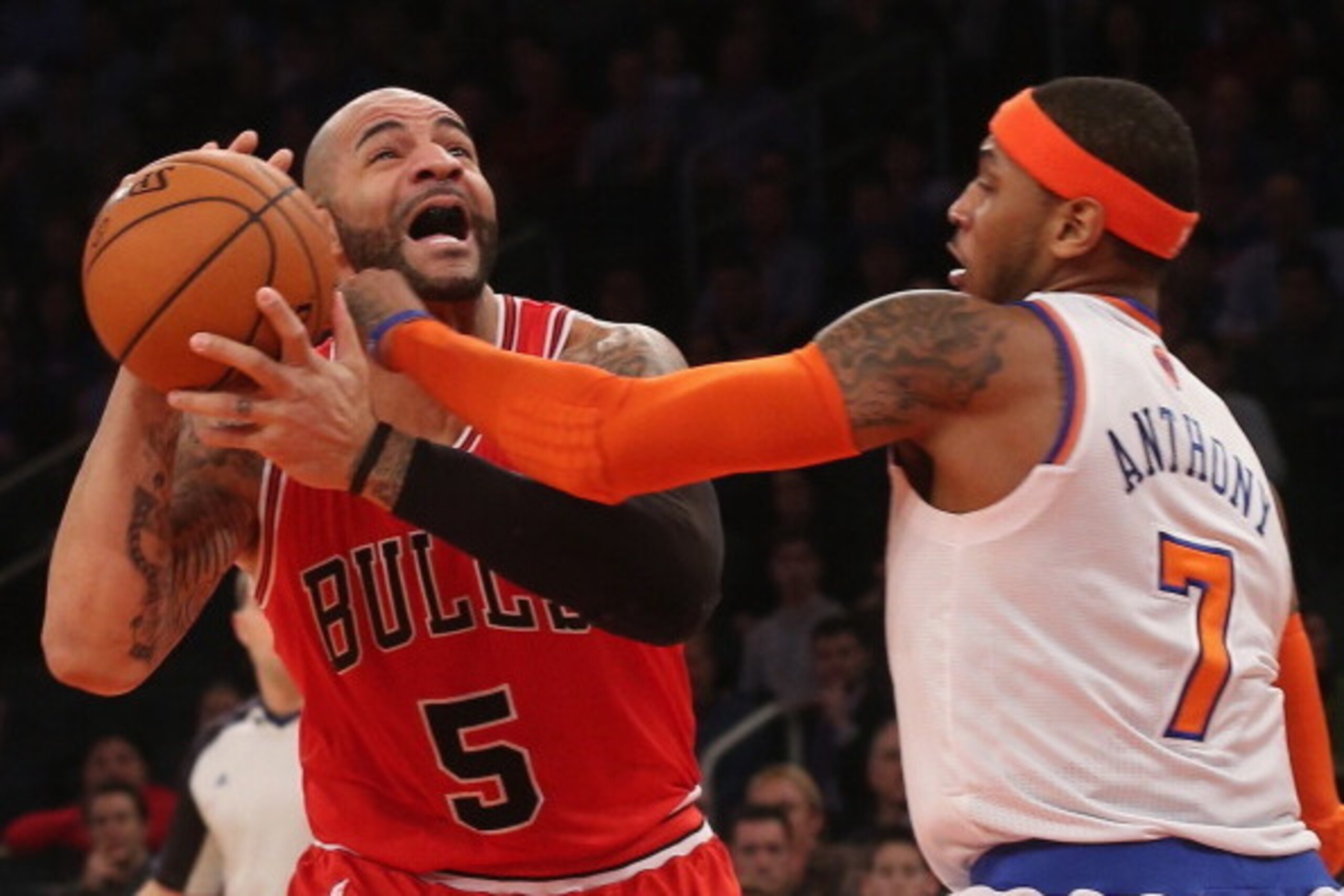 NEW YORK, NY - DECEMBER 21: Carmelo Anthony #7 of the New York Knicks fouls Carlos Boozer #5 of the Chicago Bulls in the second quarter at Madison Square Garden on December 21, 2012 in New York City. NOTE TO USER: User expressly acknowledges and agrees th