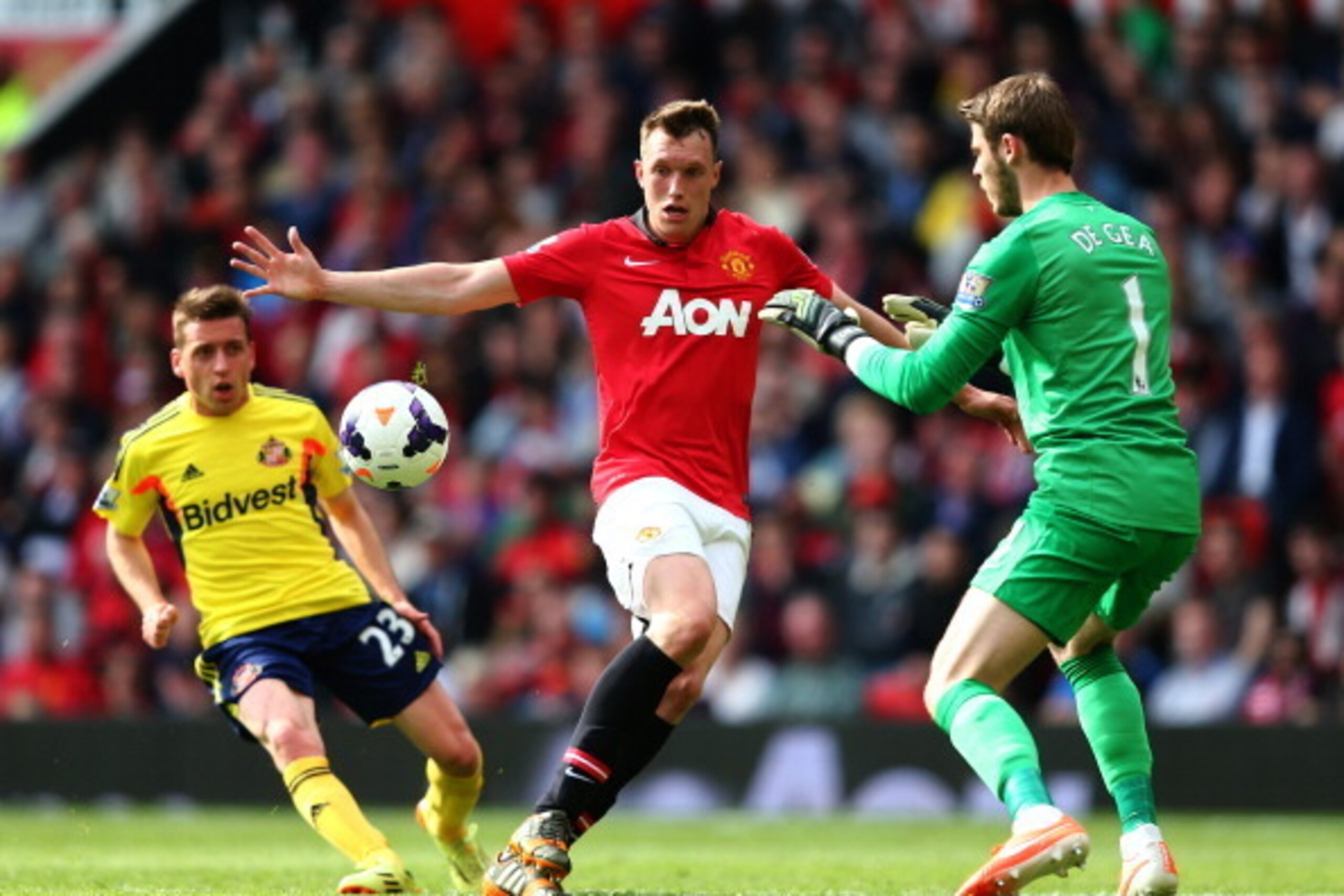 MANCHESTER, ENGLAND - MAY 03:  Phil Jones of Manchester United shepherds the ball to his goalkeeper David De Gea of Manchester United during the Barclays Premier League match between Manchester United and Sunderland at Old Trafford on May 3, 2014 in Manch