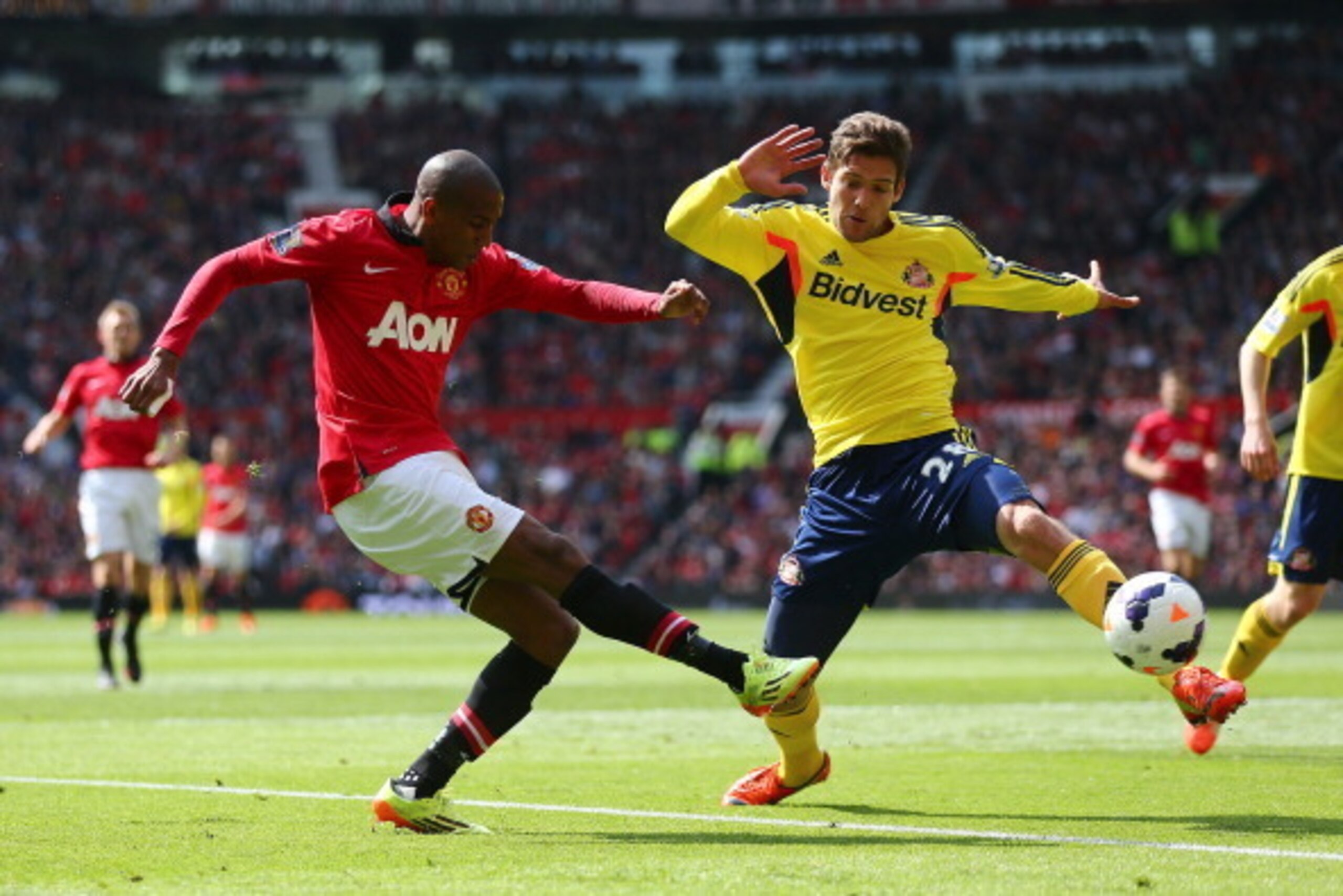 MANCHESTER, ENGLAND - MAY 03:  Ashley Young of Manchester United gets in a shot past Marcos Alonso of Sunderland during the Barclays Premier League match between Manchester United and Sunderland at Old Trafford on May 3, 2014 in Manchester, England.  (Pho