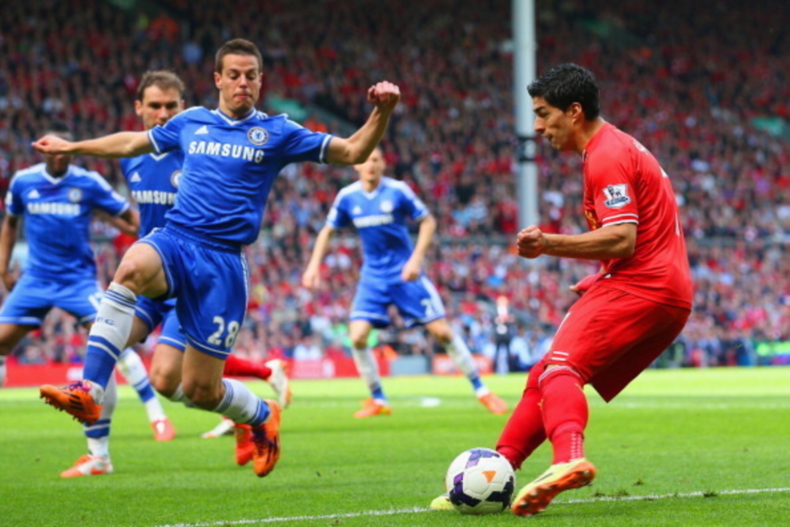 LIVERPOOL, ENGLAND - APRIL 27: Luis Suarez of Liverpool looks to go past Cesar Azpilicueta of Chelsea  during the Barclays Premier League match between Liverpool and Chelsea at Anfield on April 27, 2014 in Liverpool, England.  (Photo by Clive Brunskill/Ge