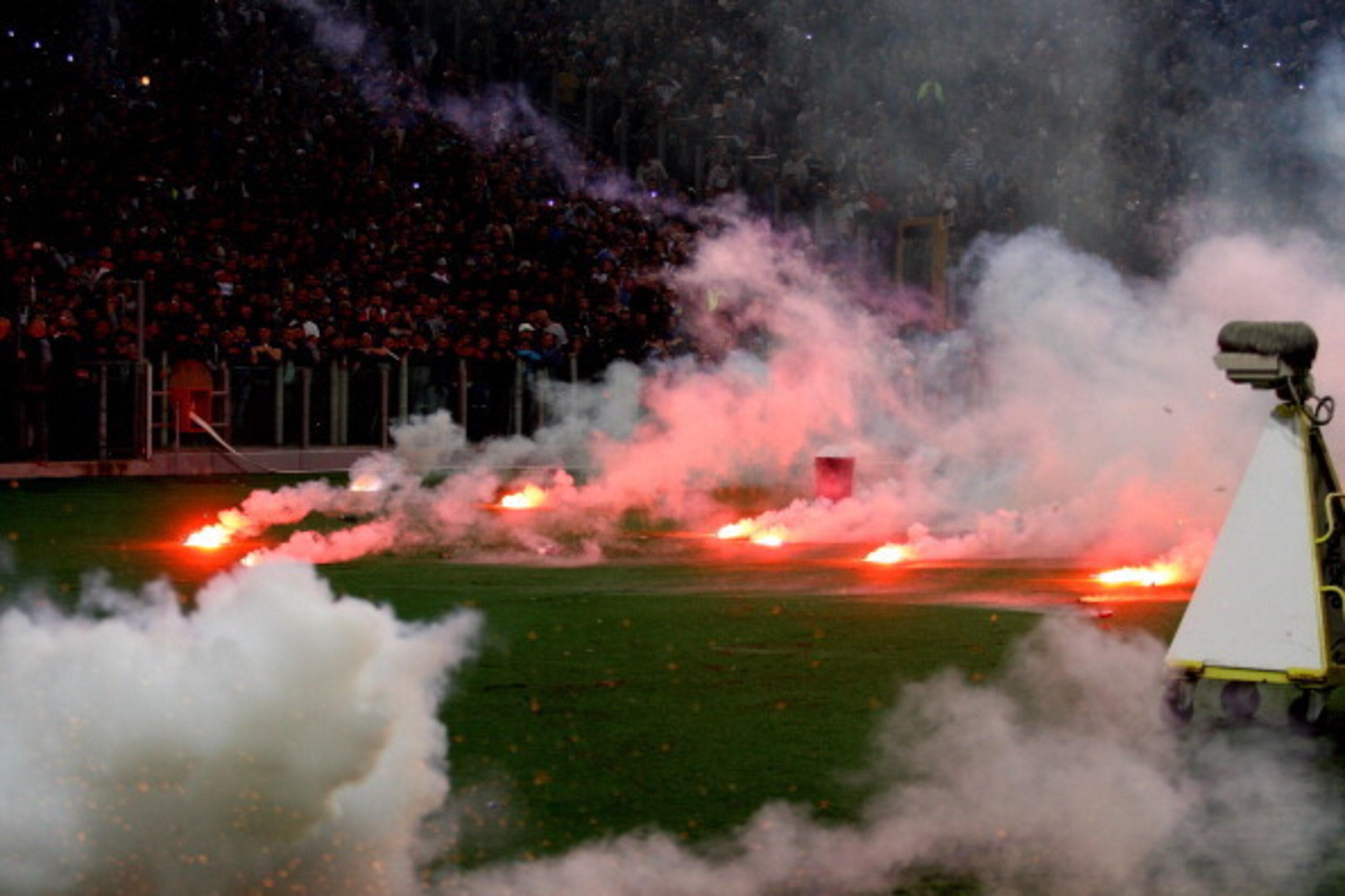 ROME, ITALY - MAY 03:  SSC Napoli fans throw flares before the TIM Cup final match between ACF Fiorentina and SSC Napoli at Olimpico Stadium on May 3, 2014 in Rome, Italy.  (Photo by Paolo Bruno/Getty Images)