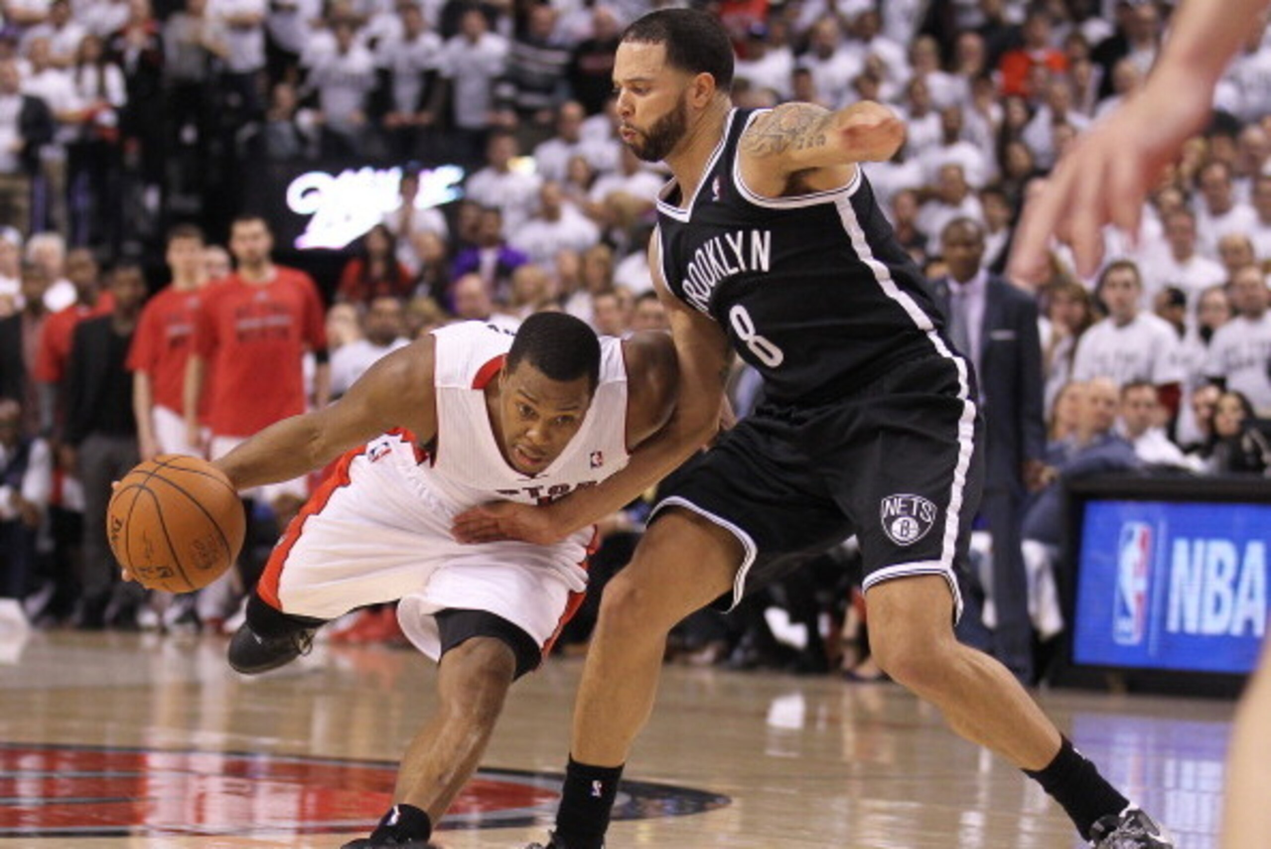 TORONTO, ON - APRIL 30:  Deron Williams #8 of the Brooklyn Nets defends against Kyle Lowry #7 of the Toronto Raptors in Game Five of the NBA Eastern Conference Quarterfinals at the Air Canada Centre on April 30, 2014 in Toronto, Ontario, Canada. The Rapto
