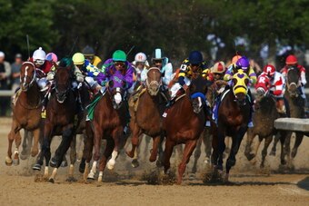 LOUISVILLE, KY - MAY 03:  California Chrome #5, ridden by Victor Espinoza, comes out of the third turn enroute to winning the 140th running of the Kentucky Derby at Churchill Downs on May 3, 2014 in Louisville, Kentucky.  (Photo by Andy Lyons/Getty Images