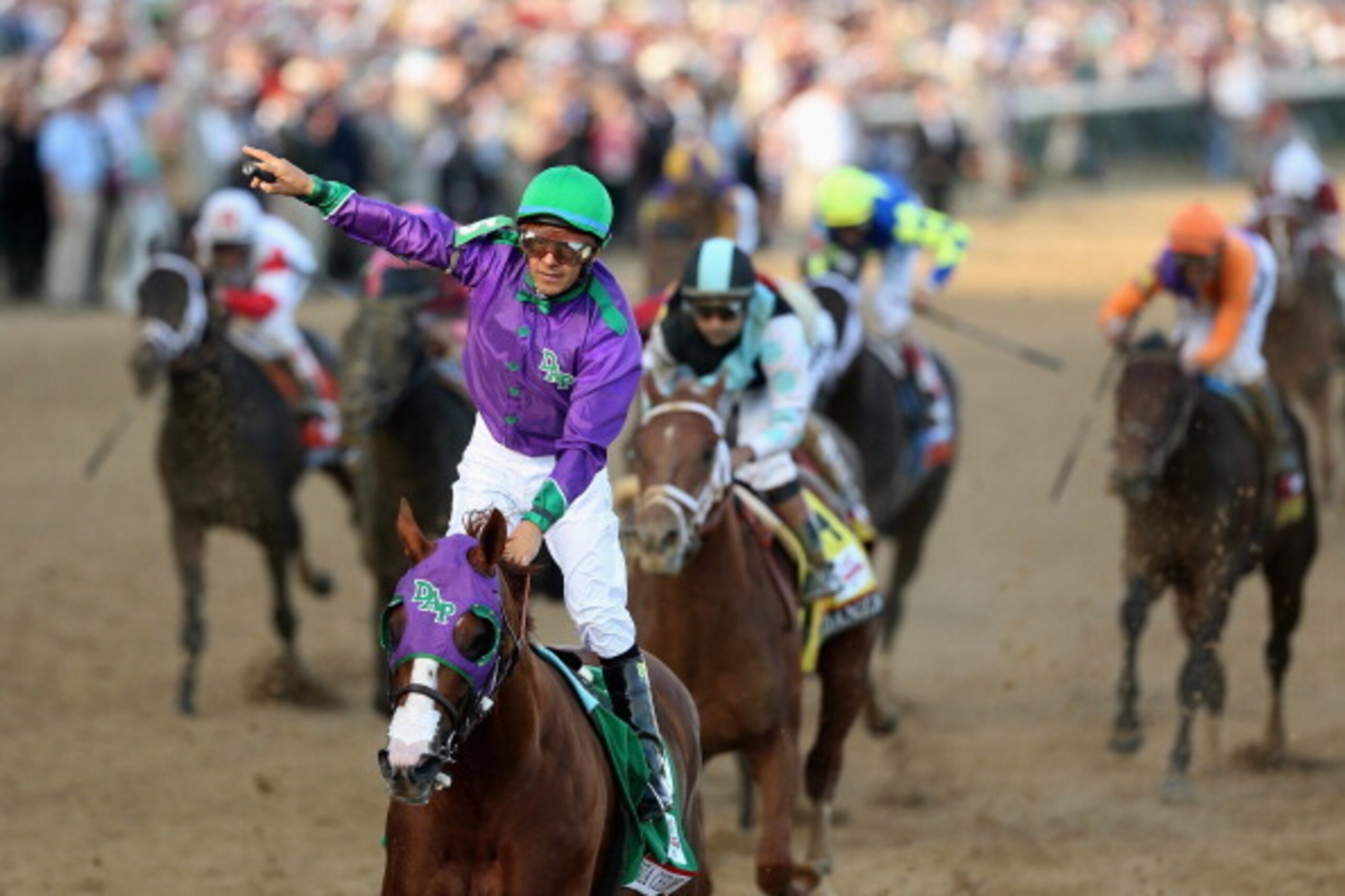 LOUISVILLE, KY - MAY 03:  Jockey Victor Espinoza celebrates atop of California Chrome #5 after crossing the finish line to win the 140th running of the Kentucky Derby at Churchill Downs on May 3, 2014 in Louisville, Kentucky.  (Photo by Matthew Stockman/G
