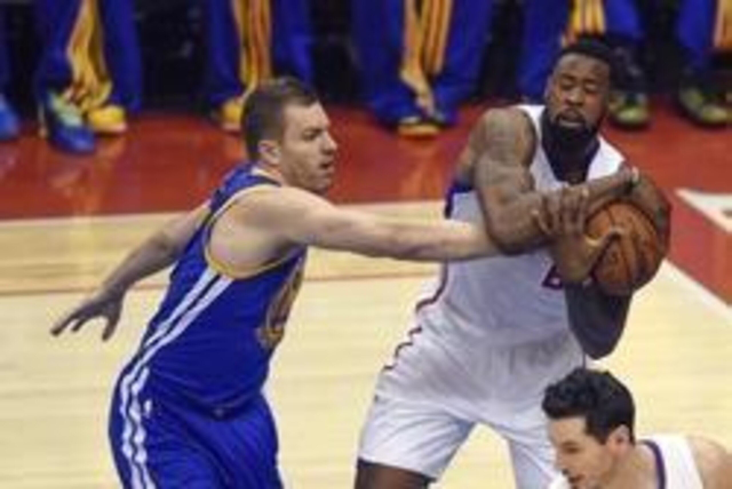 May 3, 2014; Los Angeles, CA, USA; Los Angeles Clippers center DeAndre Jordan (right) attempts to hold onto the ball defended by Golden State Warriors guard Stephen Curry (left) during the first quarter in game seven of the first round of the 2014 NBA Pla