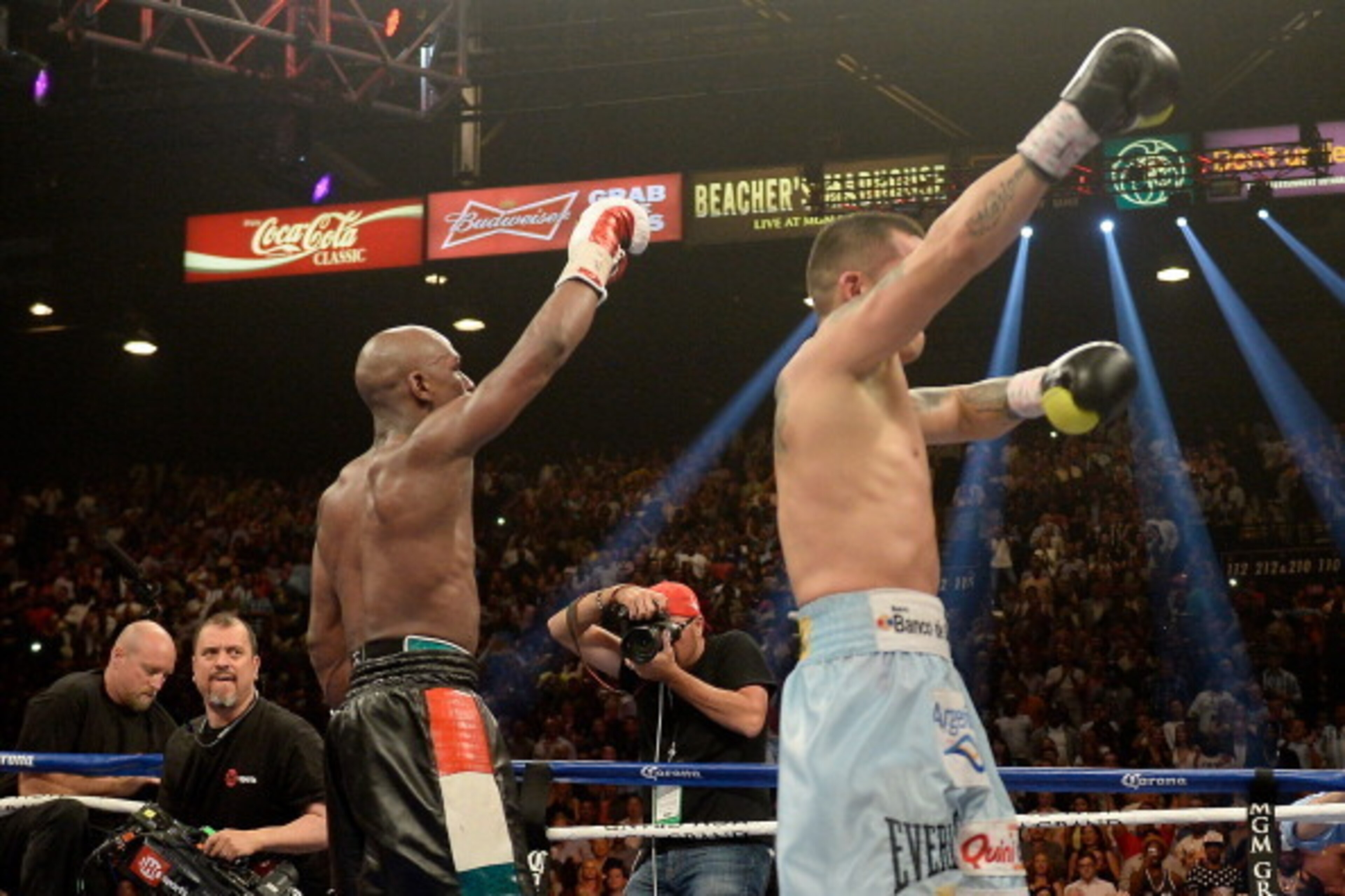 LAS VEGAS, NV - MAY 03:  (L-R) Floyd Mayweather Jr. and Marcos Maidana both put up their arms after the 12th round during their WBC/WBA welterweight unification fight at the MGM Grand Garden Arena on May 3, 2014 in Las Vegas, Nevada.  (Photo by Harry How/