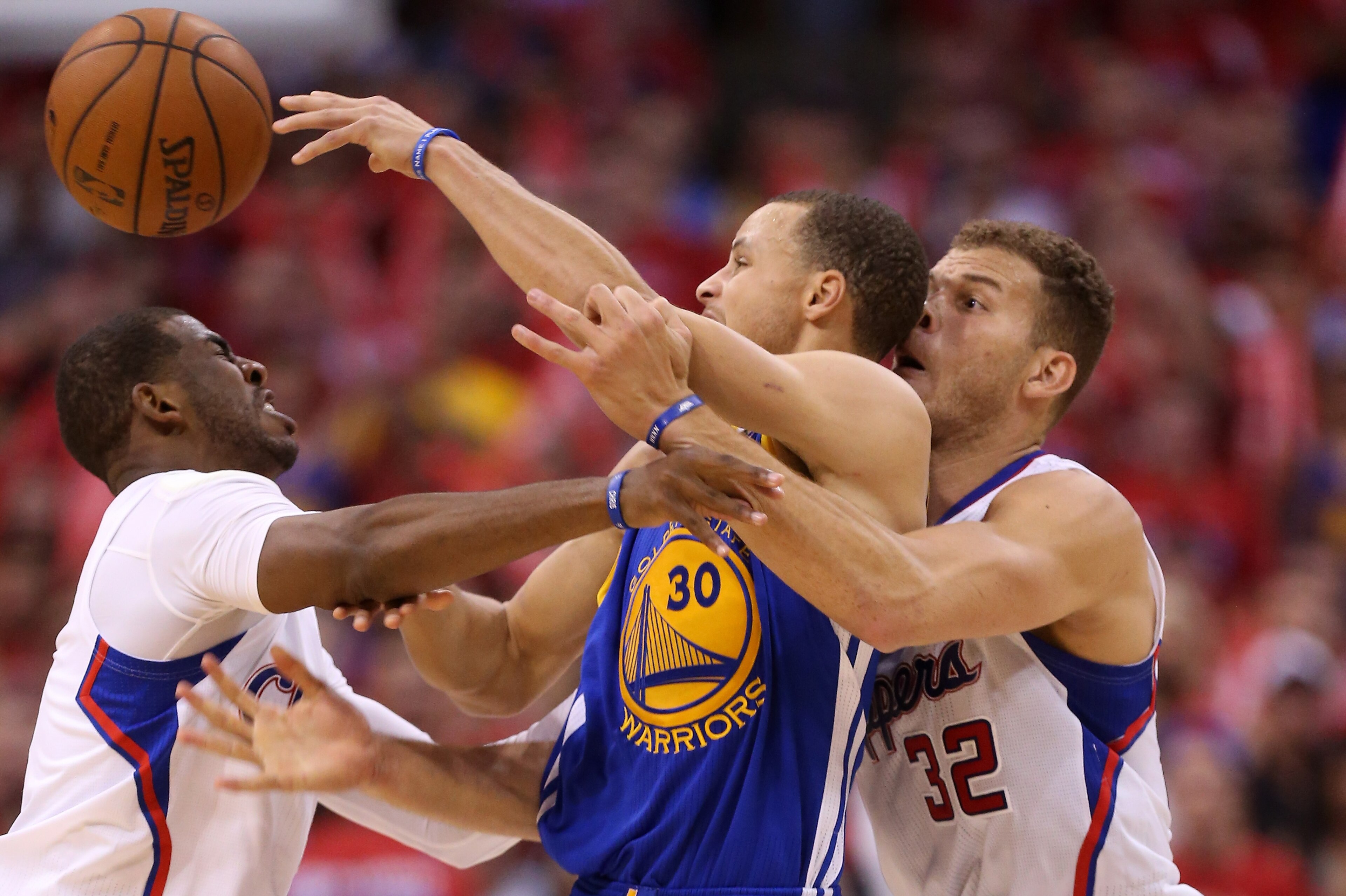 LOS ANGELES, CA - MAY 03:  Stephen Curry #30 of the Golden State Warriors tries to pass the ball between Chris Paul #3 and Blake Griffin #32 of the Los Angeles Clippers in Game Seven of the Western Conference Quarterfinals during the 2014 NBA Playoffs at