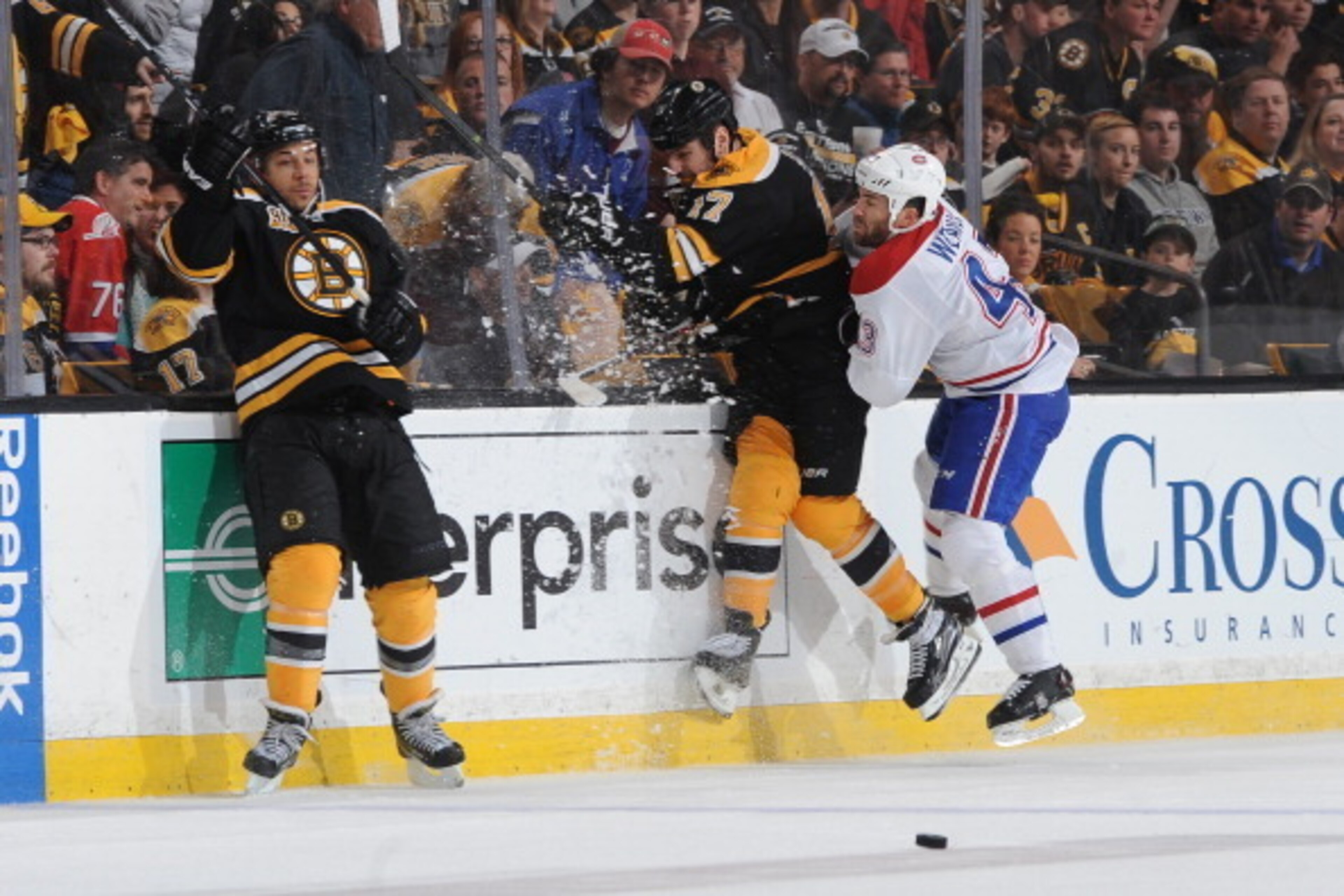 BOSTON, MA - MAY 3: Milan Lucic #17 of the Boston Bruins collides with the boards against Mike Weaver #43 of the Montreal Canadiens in Game Two of the Second Round of the 2014 Stanley Cup Playoffs at TD Garden on May 3, 2014 in Boston, Massachusetts. (Pho