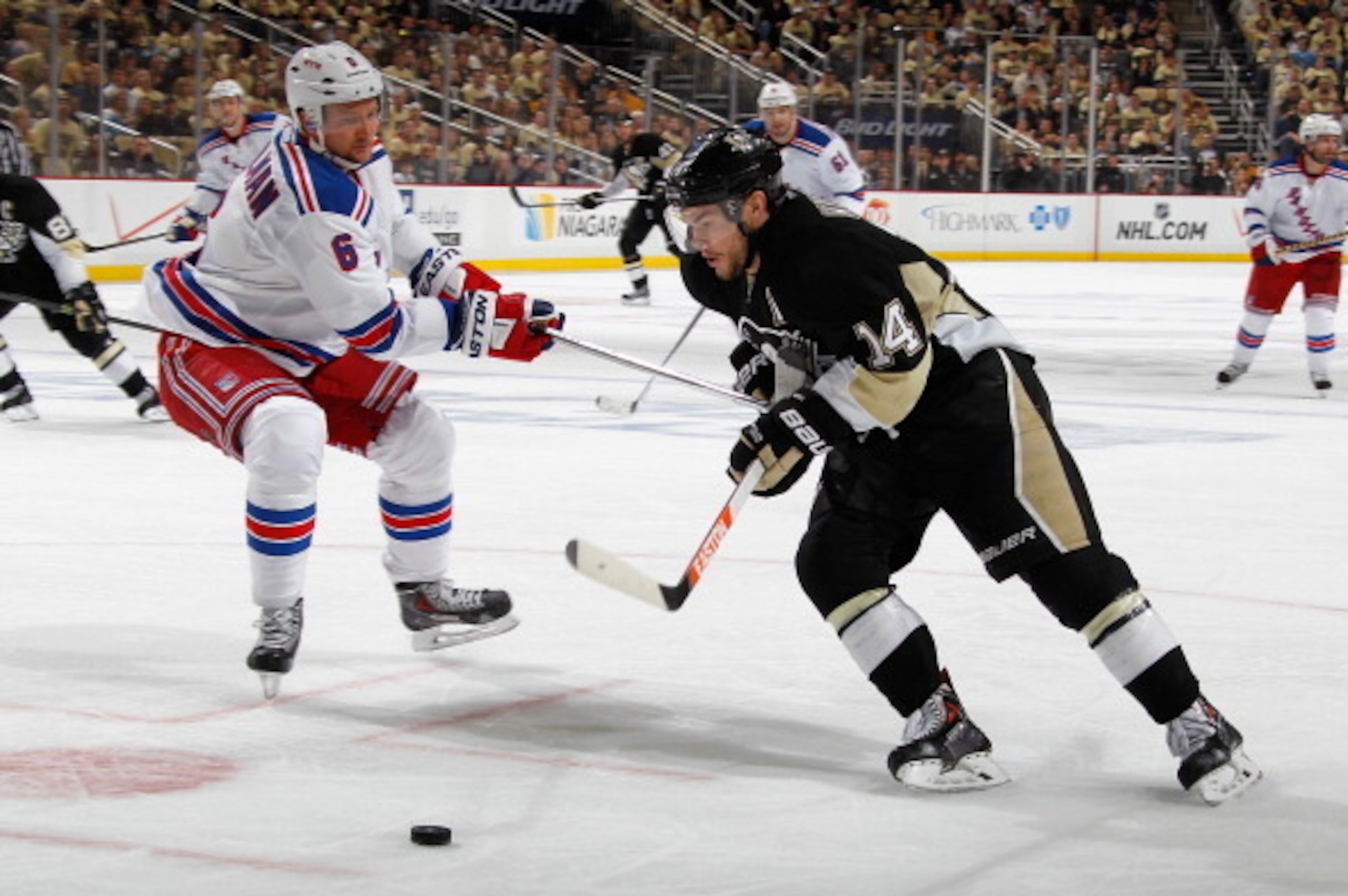 PITTSBURGH, PA - MAY 2:  Chris Kunitz #14 of the Pittsburgh Penguins moves the puck in front of Anton Stralman #6 of the New York Rangers in Game One of the Second Round of the 2014 Stanley Cup Playoffs at Consol Energy Center on May 2, 2014 in Pittsburgh