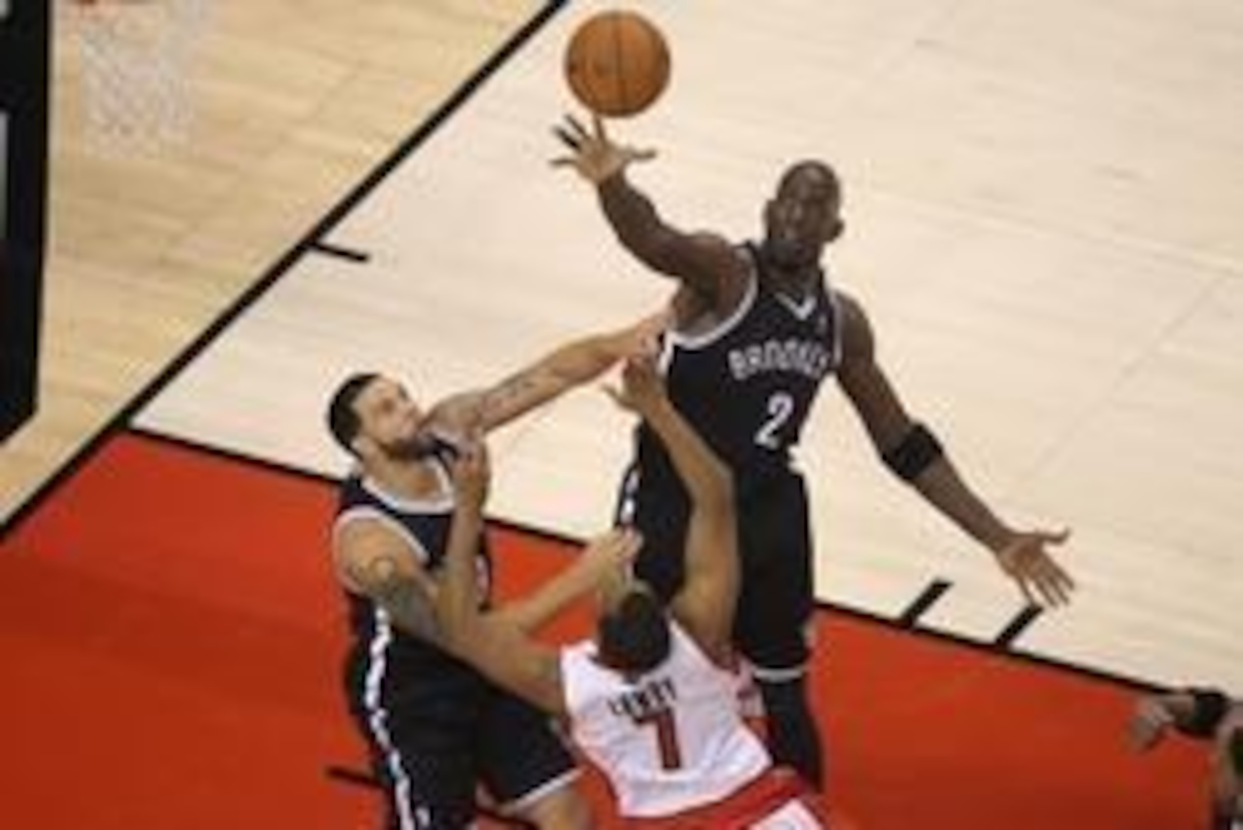 May 4, 2014; Toronto, Ontario, CAN; Toronto Raptors point guard Kyle Lowry (7) shoots against Brooklyn Nets point guard Deron Williams (8) and forward Kevin Garnett (2) in game seven of the first round of the 2014 NBA Playoffs at Air Canada Centre. Mandat