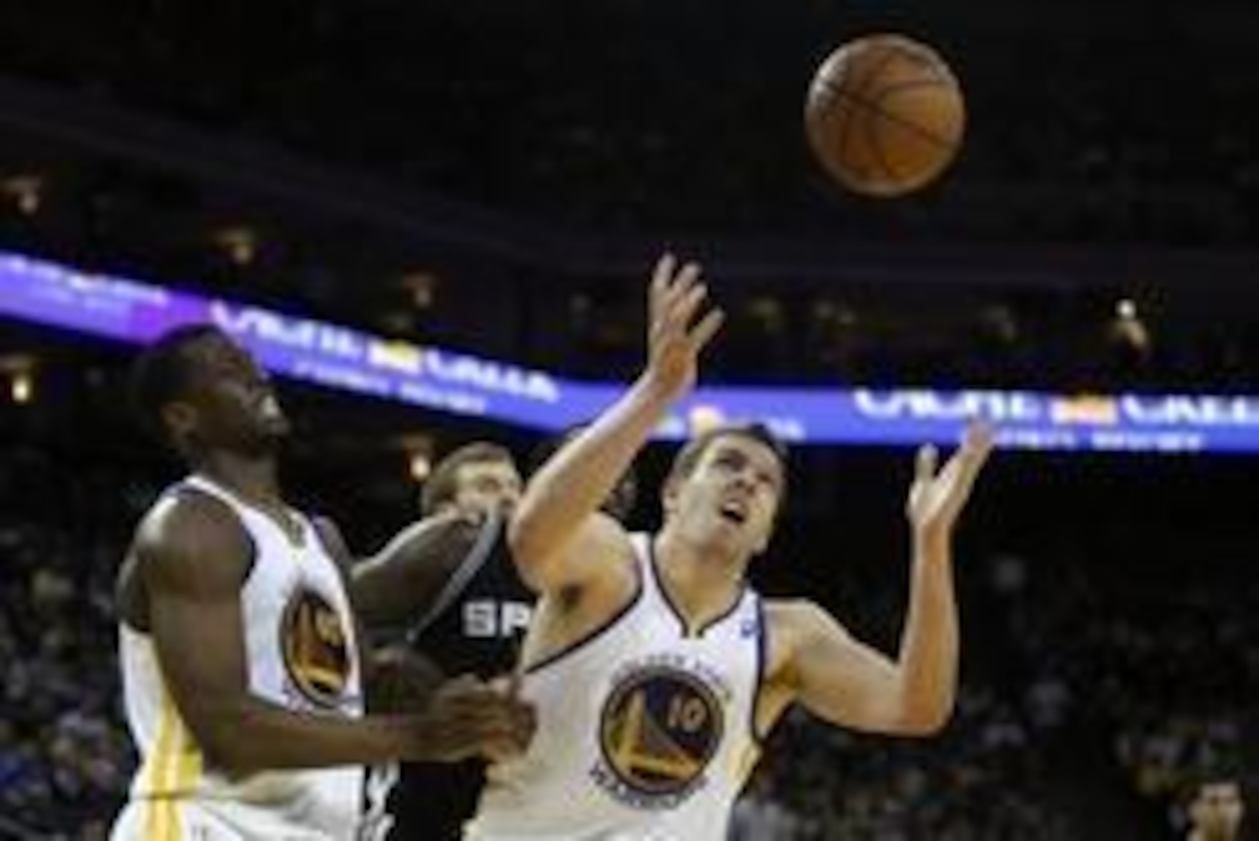 April 15, 2013; Oakland, CA, USA; Golden State Warriors power forward David Lee (10) looks to control the rebound with small forward Harrison Barnes (40) ahead of San Antonio Spurs center DeJuan Blair (45) during the third quarter at Oracle Arena. The Gol