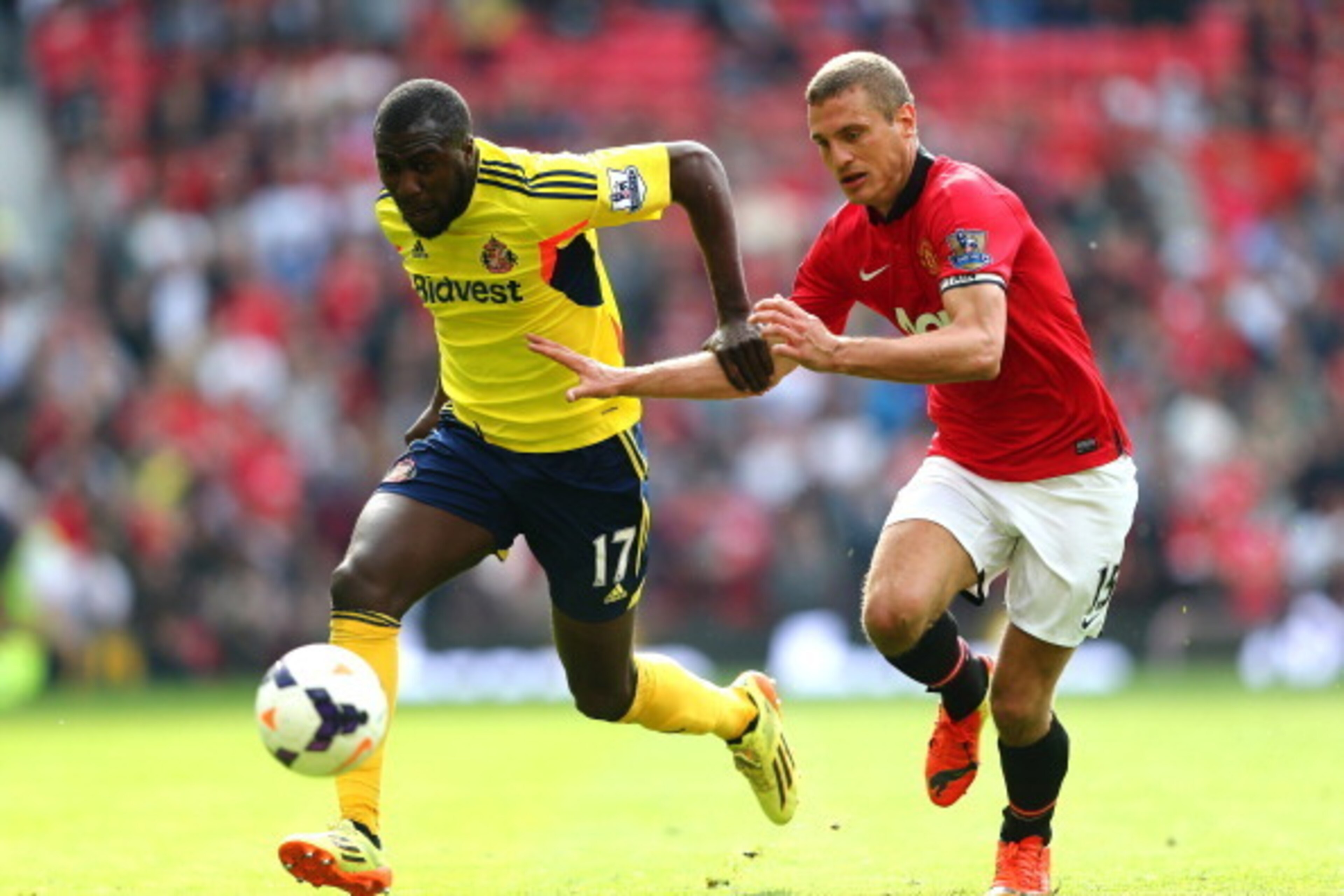 MANCHESTER, ENGLAND - MAY 03:  Jozy Altidore of Sunderland is pursued by Nemanja Vidic of Manchester United during the Barclays Premier League match between Manchester United and Sunderland at Old Trafford on May 3, 2014 in Manchester, England.  (Photo by