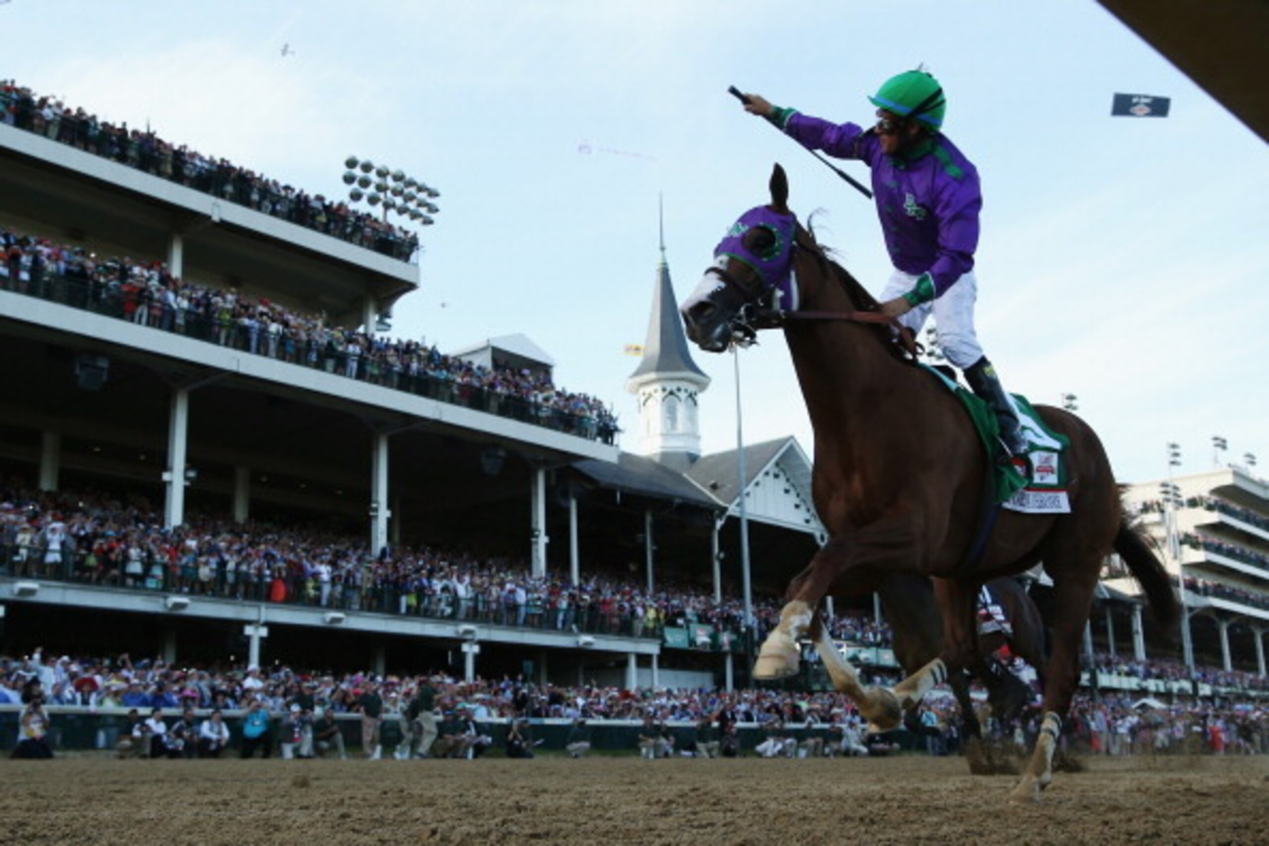 LOUISVILLE, KY - MAY 03:  Jockey Victor Espinoza celebrates atop of California Chrome #5 after crossing the finish line to win the 140th running of the Kentucky Derby at Churchill Downs on May 3, 2014 in Louisville, Kentucky.  (Photo by Matthew Stockman/G