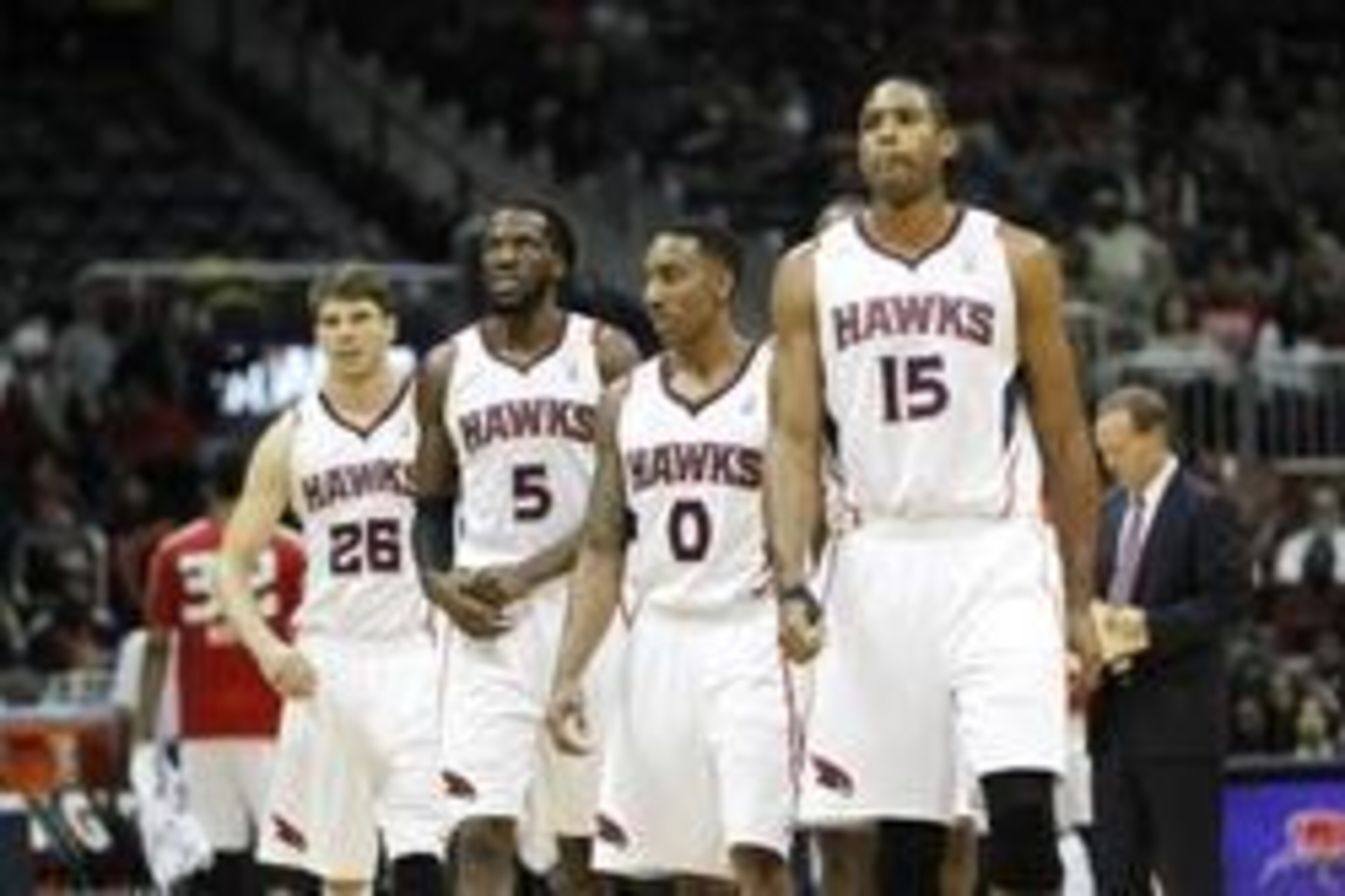Dec 20, 2013; Atlanta, GA, USA; Atlanta Hawks shooting guard Kyle Korver (26) and small forward DeMarre Carroll (5) and point guard Jeff Teague (0) and center Al Horford (15) walk on the court against the Utah Jazz in the third quarter at Philips Arena. M